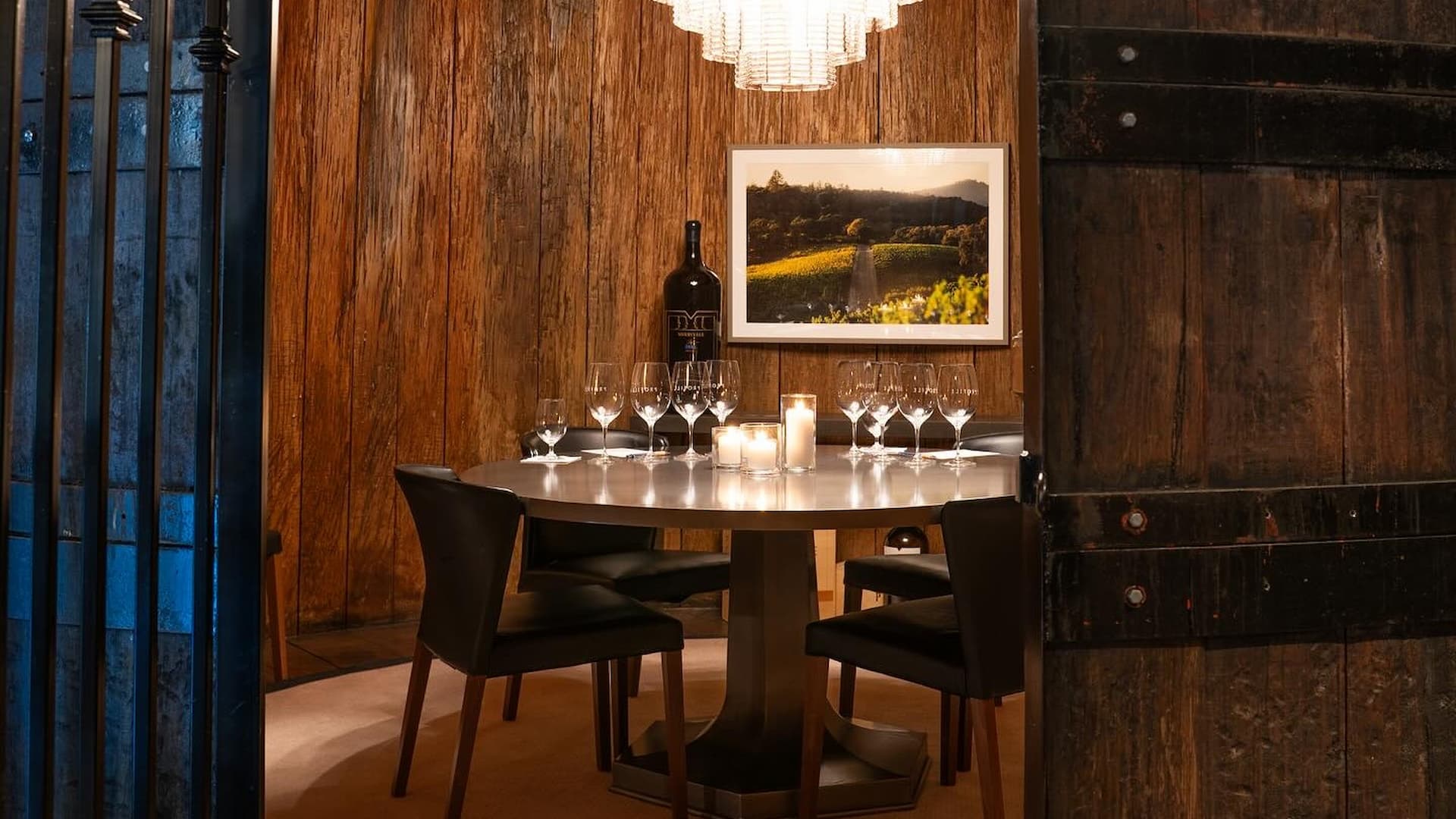 Cozy wine tasting room with chandelier lighting.