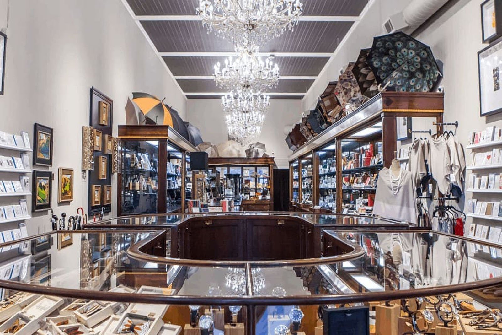 Elegant store with chandeliers and various items displayed.