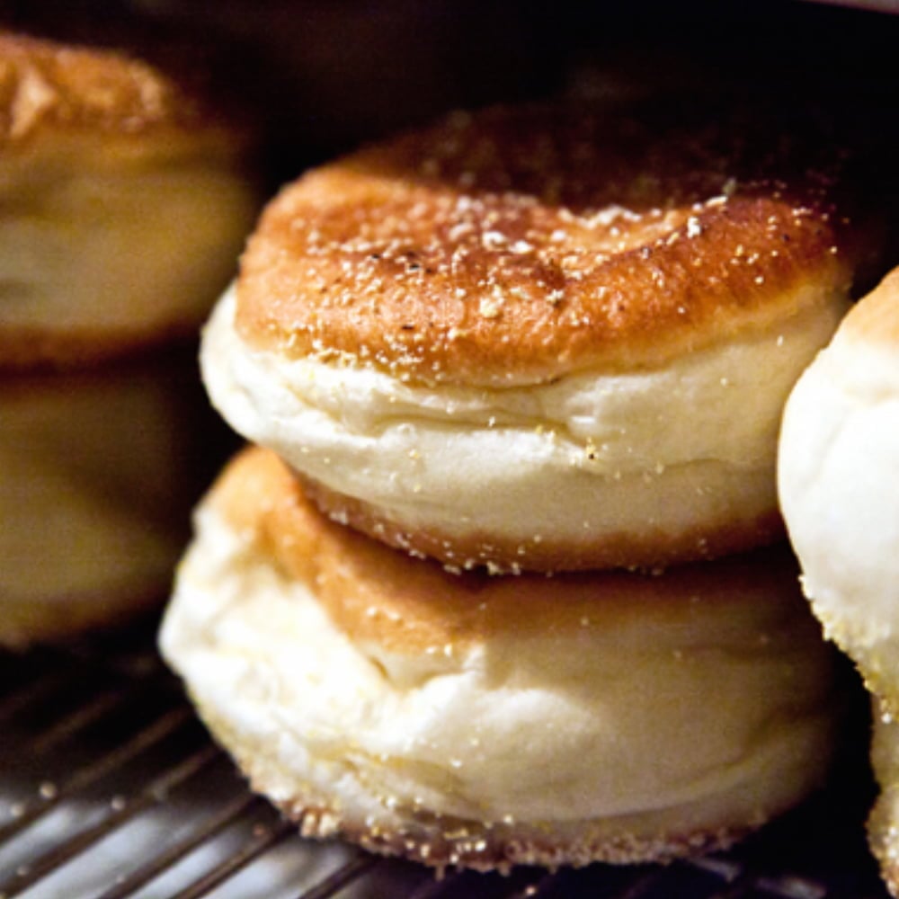 Close-up of golden sugar-topped pastries on rack