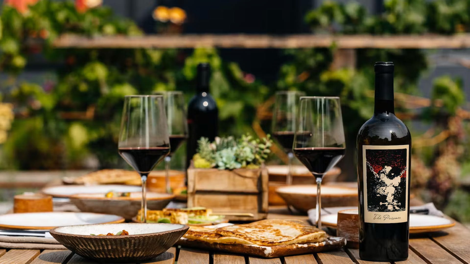 Outdoor dining table with wine and food