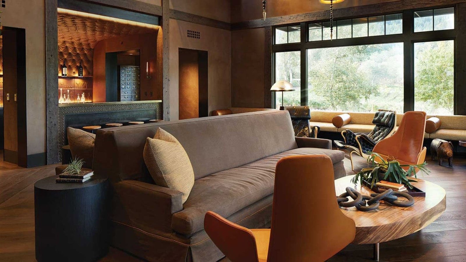 Modern living room with bar and large windows.