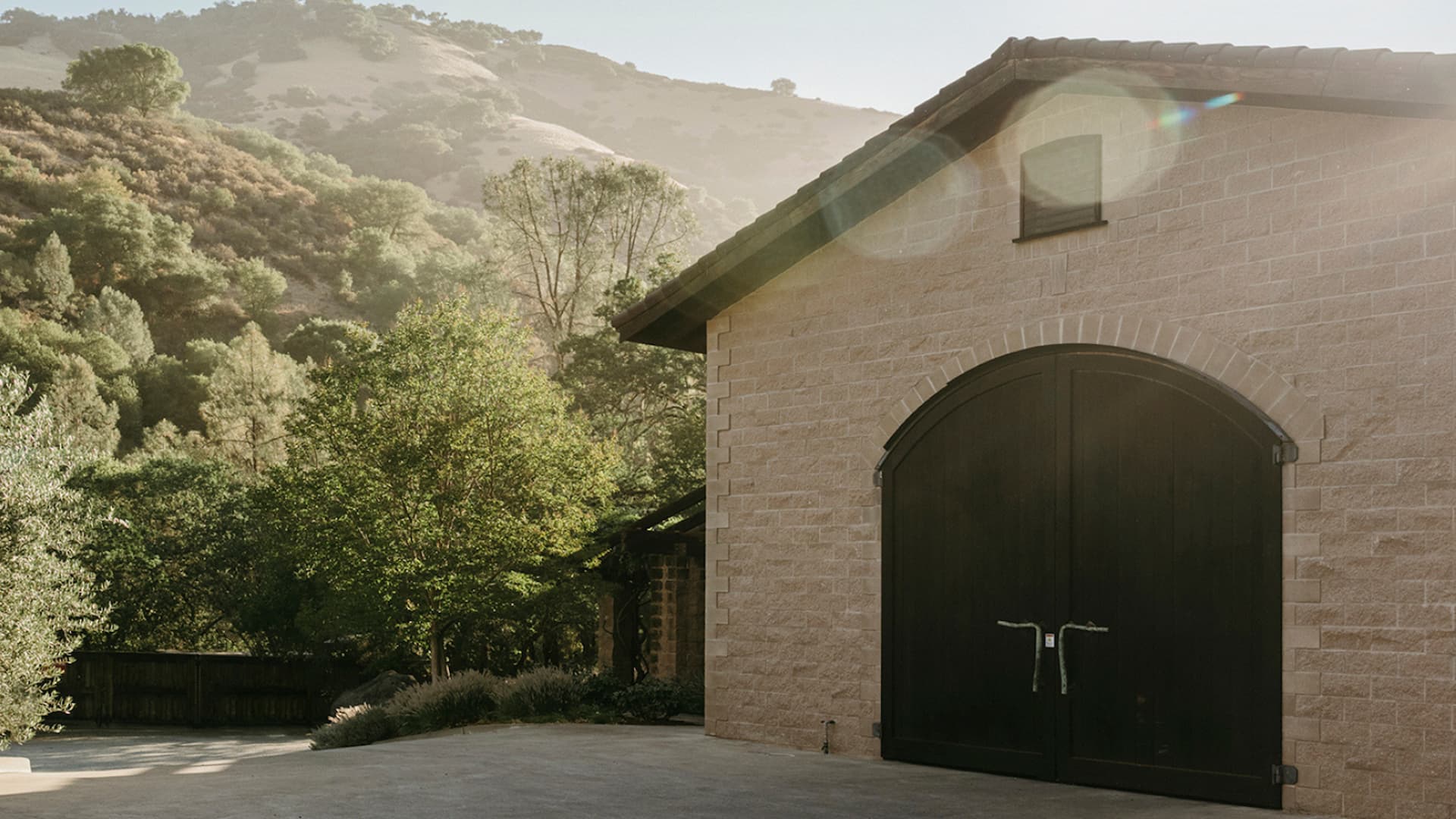 Stone building with large wooden doors in nature