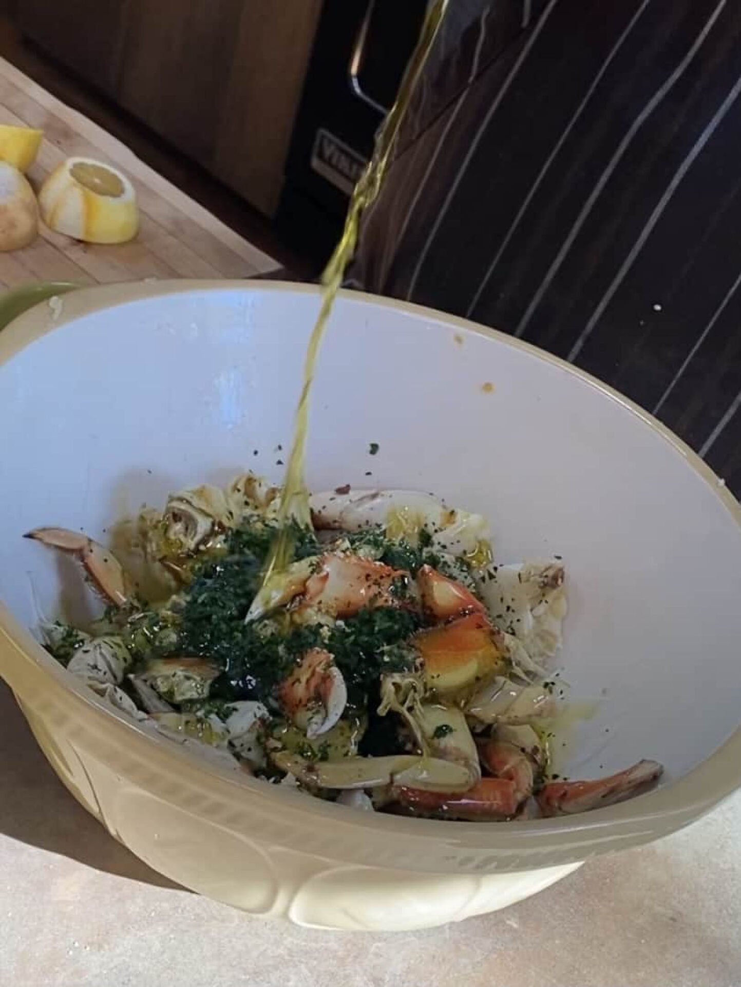 Preparing crab salad with fresh herbs and lemon.