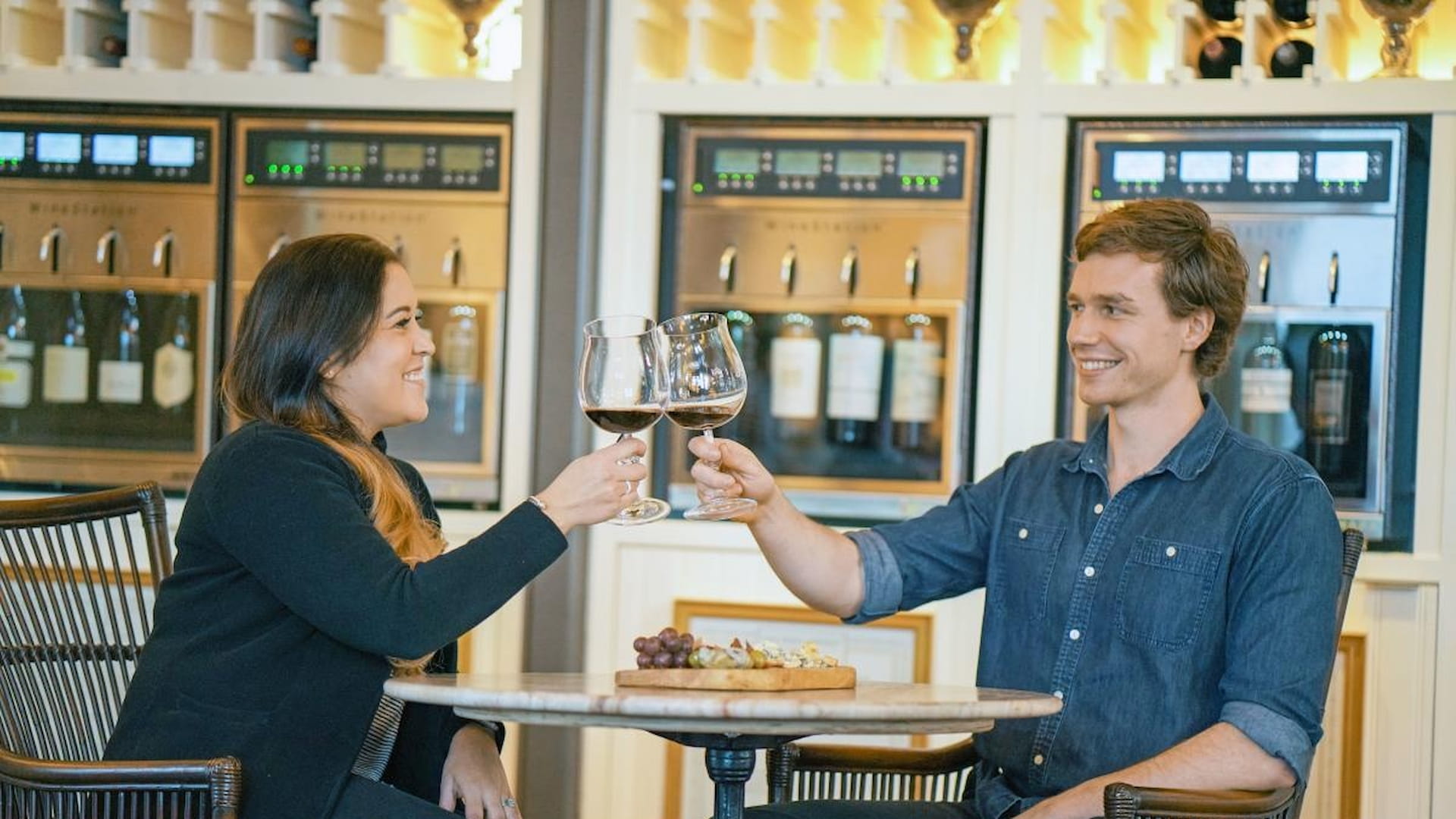 Couple toasting wine in a tasting room.