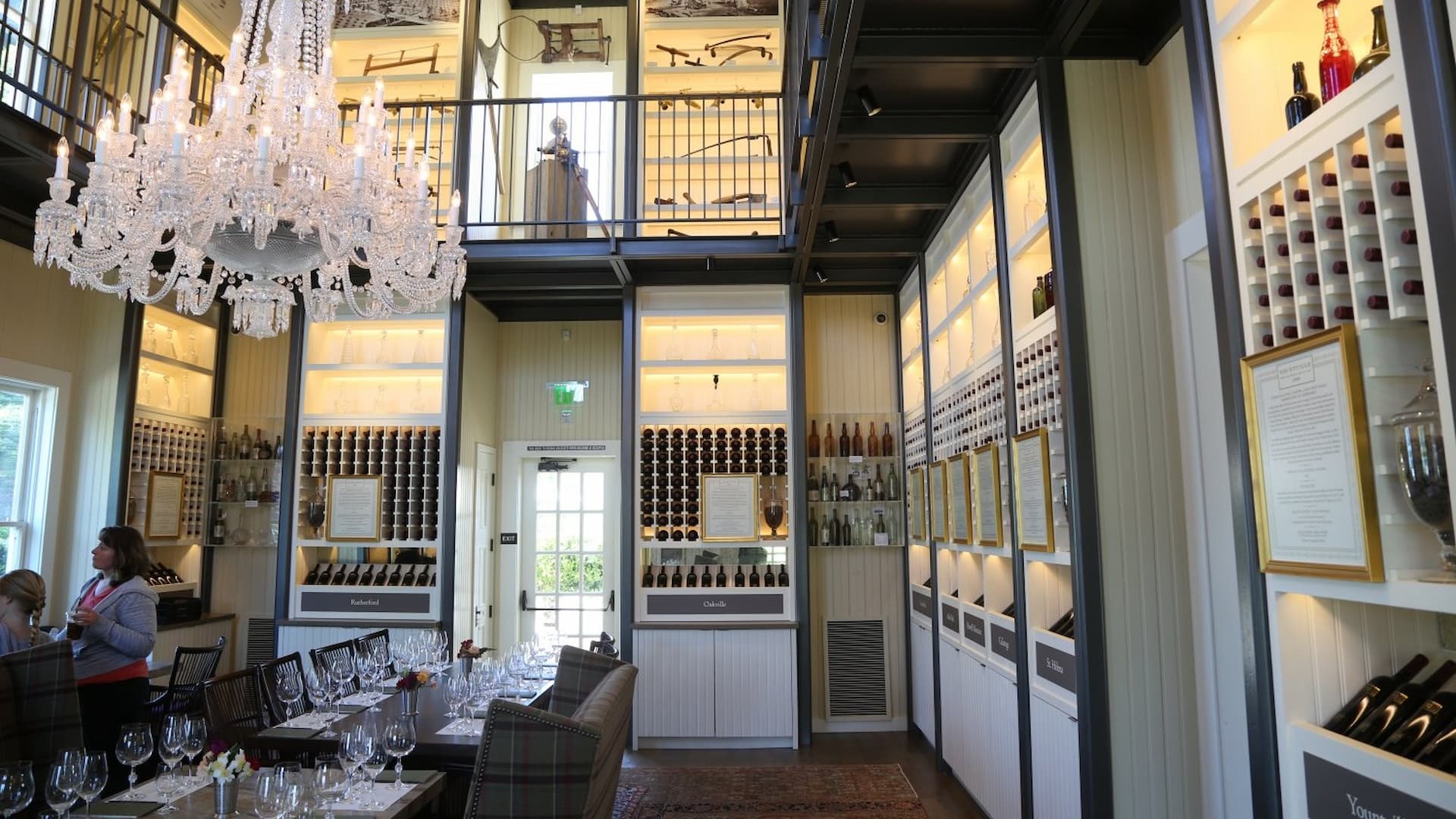 Elegant winery tasting room with chandelier and wine racks.