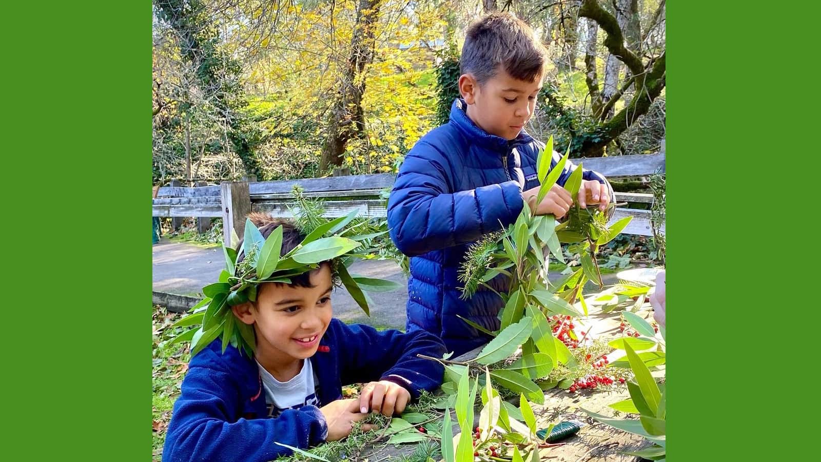 Children crafting leaf crowns in park