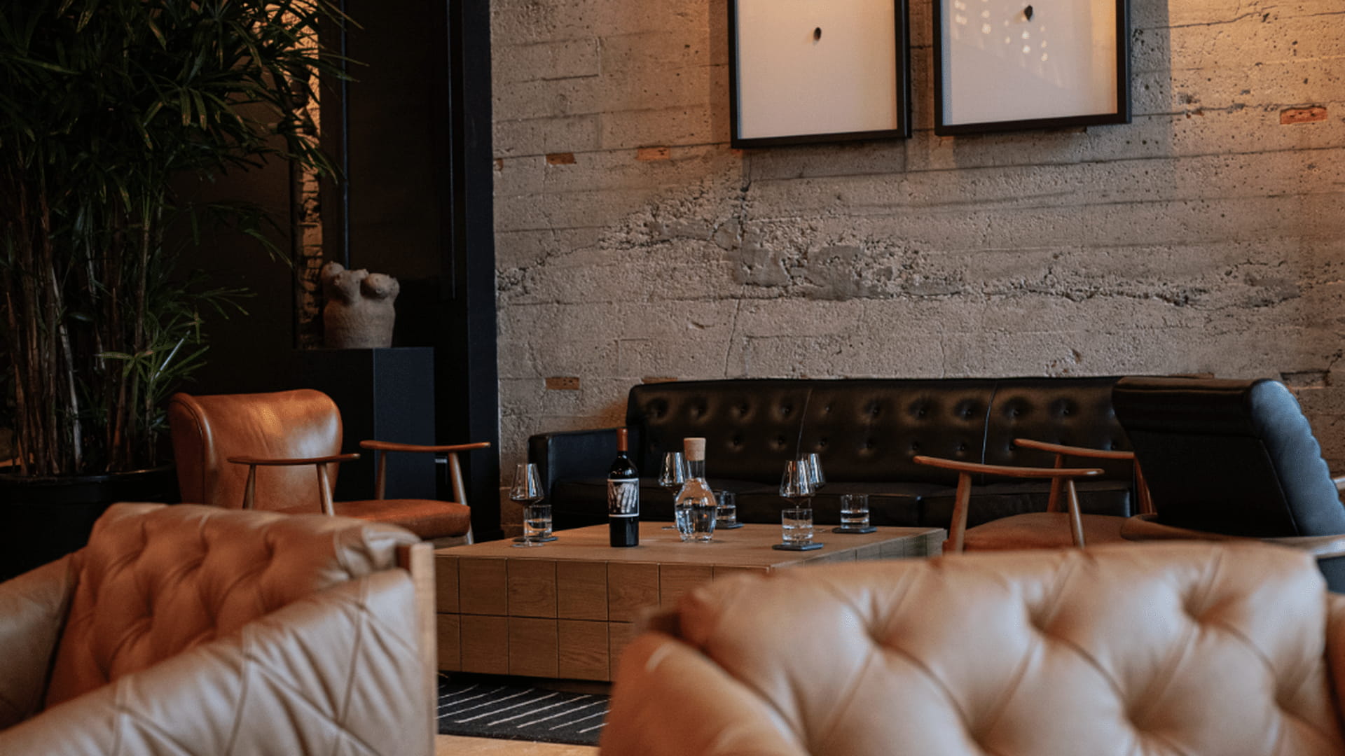 Cozy living room with leather chairs and table.