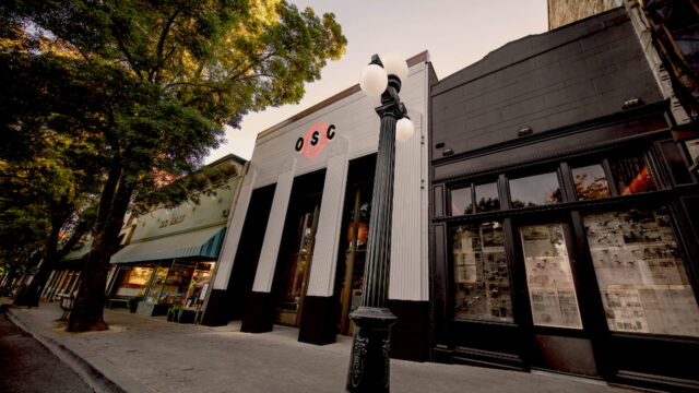 Street view of a shopfront with trees.