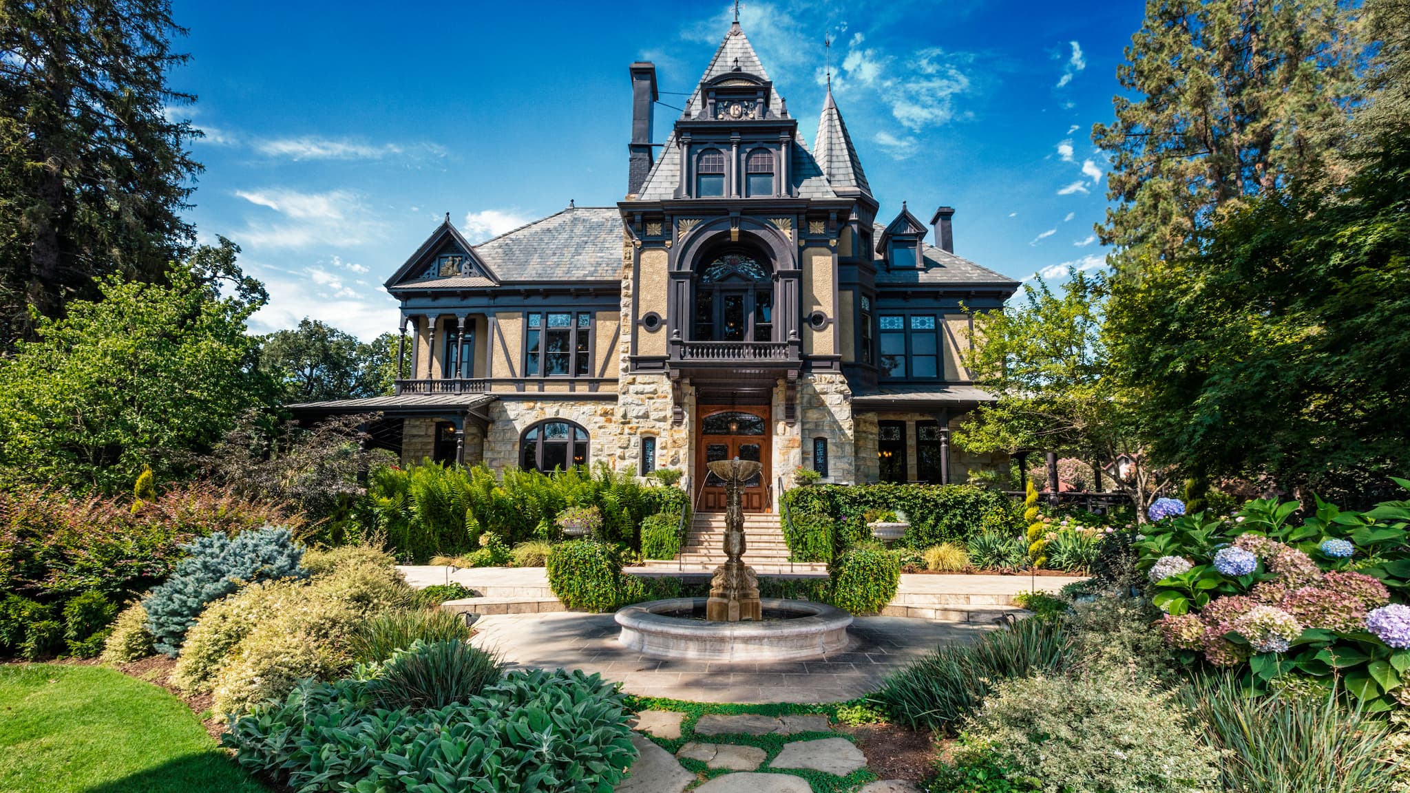 Victorian mansion with garden and fountain