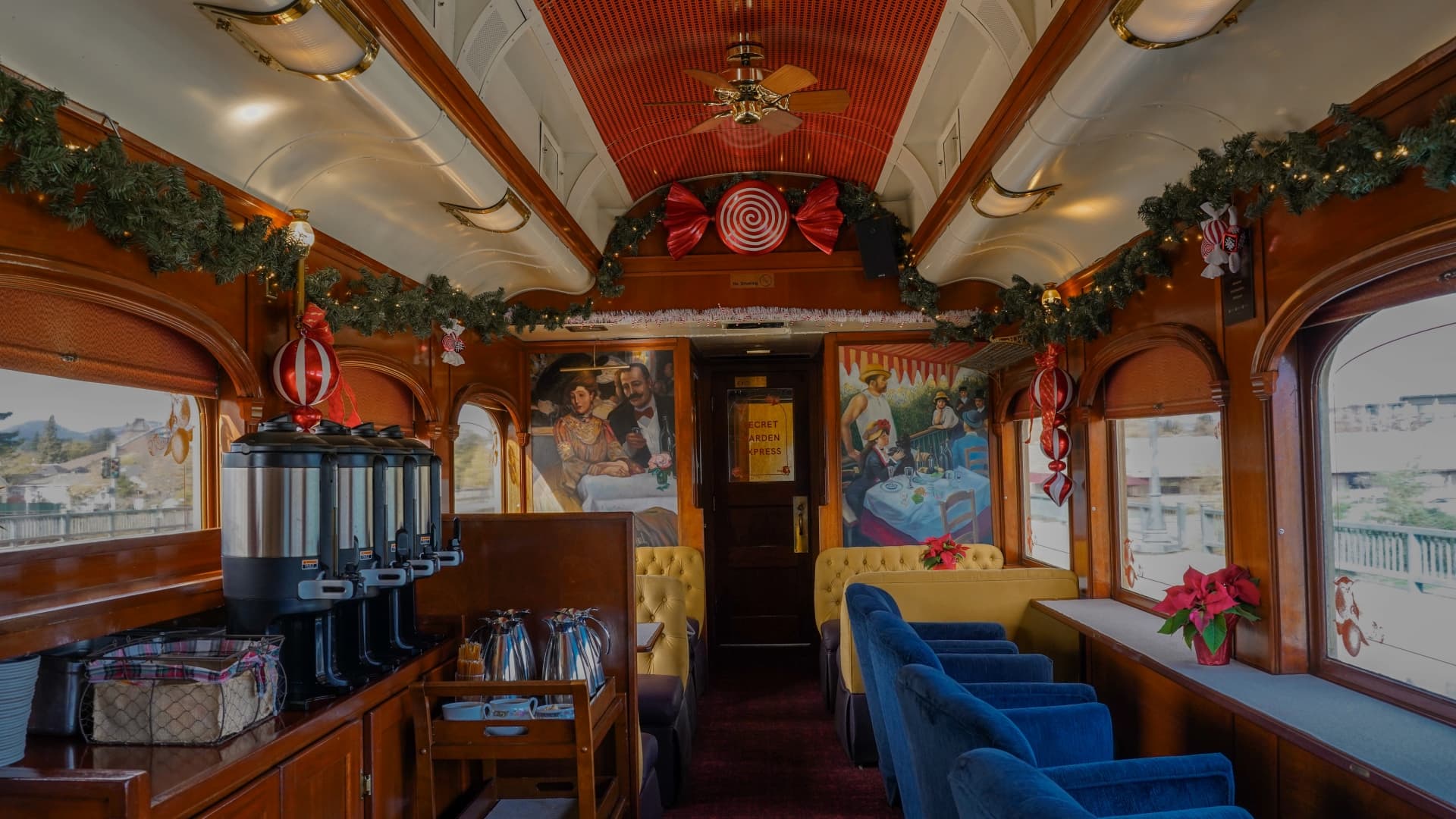 Festive train interior with holiday decorations.