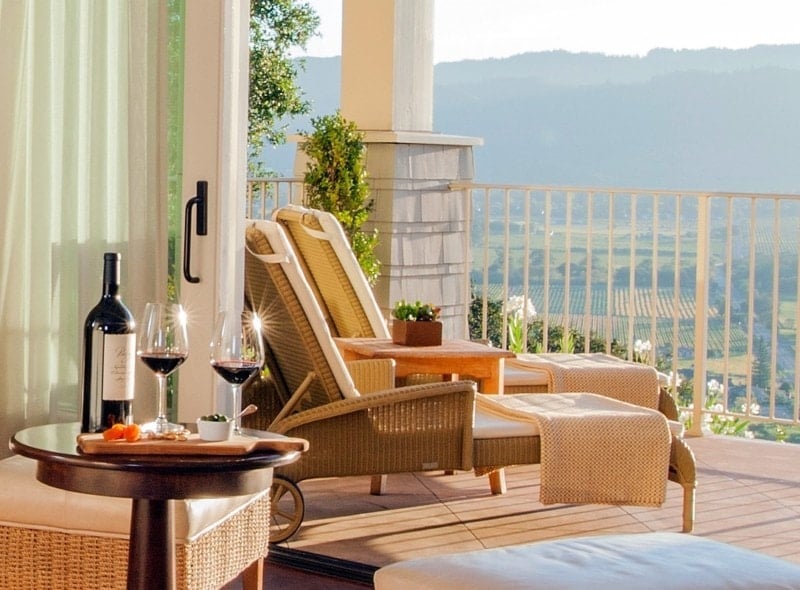 Mountain view patio with wine and lounge chairs.