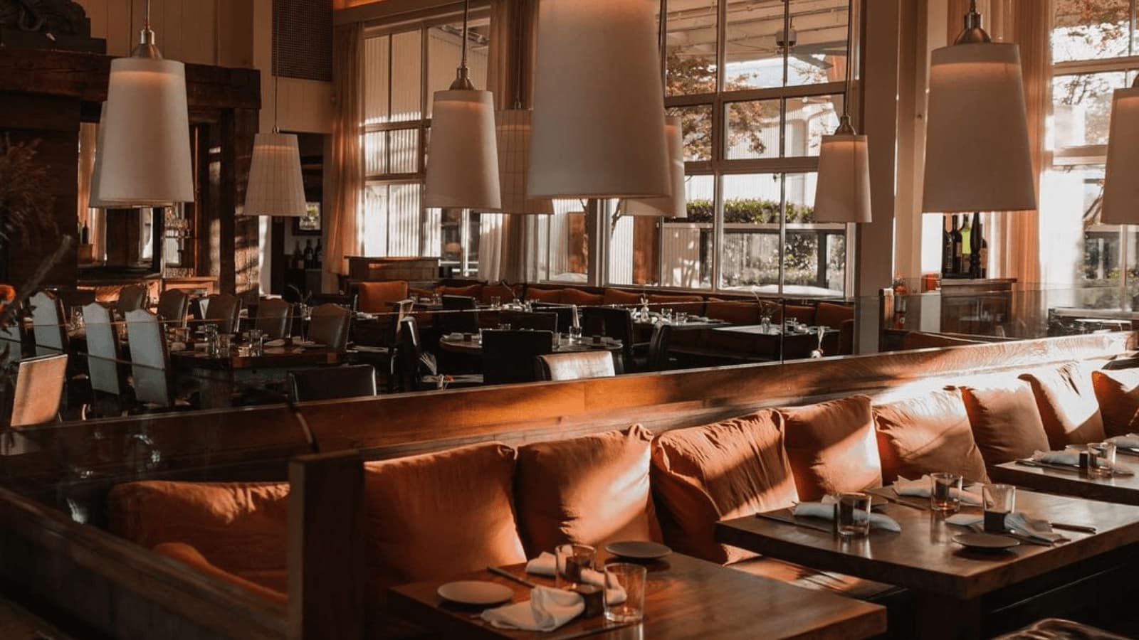 Cozy restaurant with tables and pendant lights.