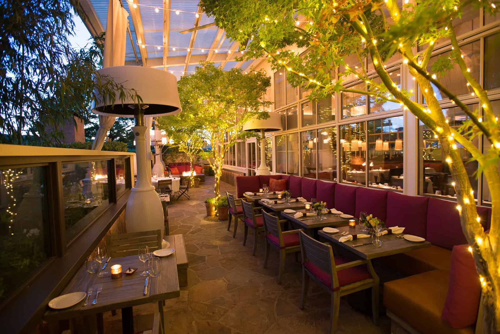 Outdoor restaurant with festive lights in the evening.