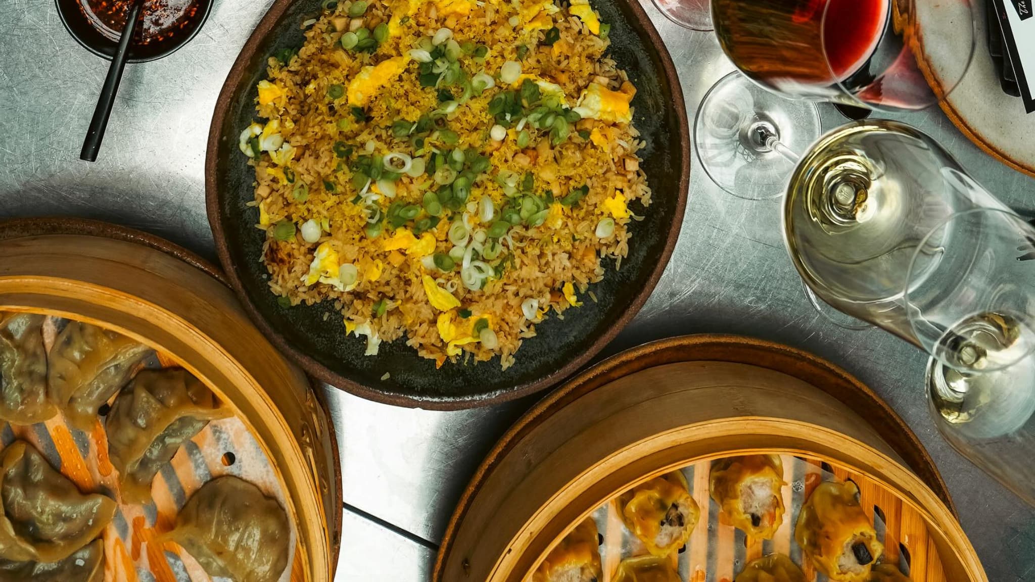 Fried rice, dumplings, and wine overhead view