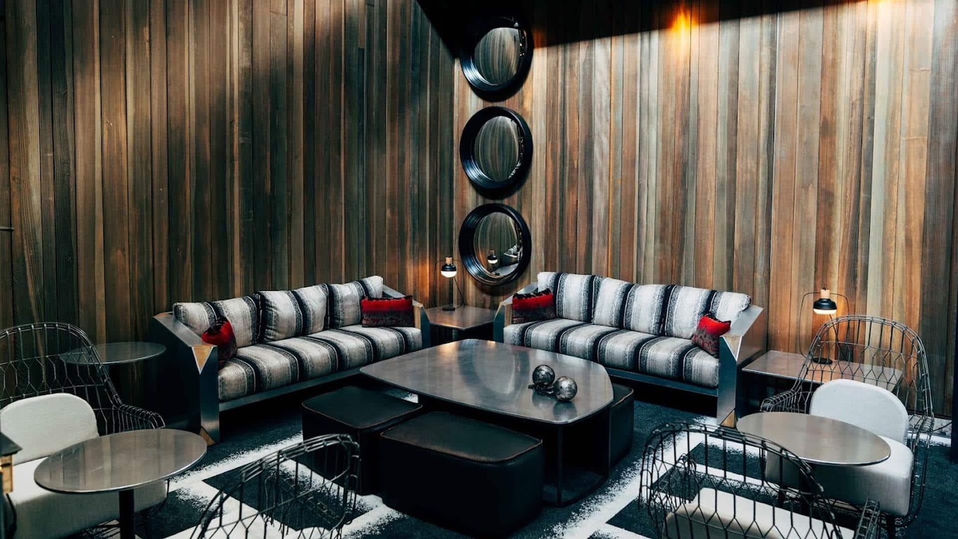 Modern lounge with sofas and wooden walls.