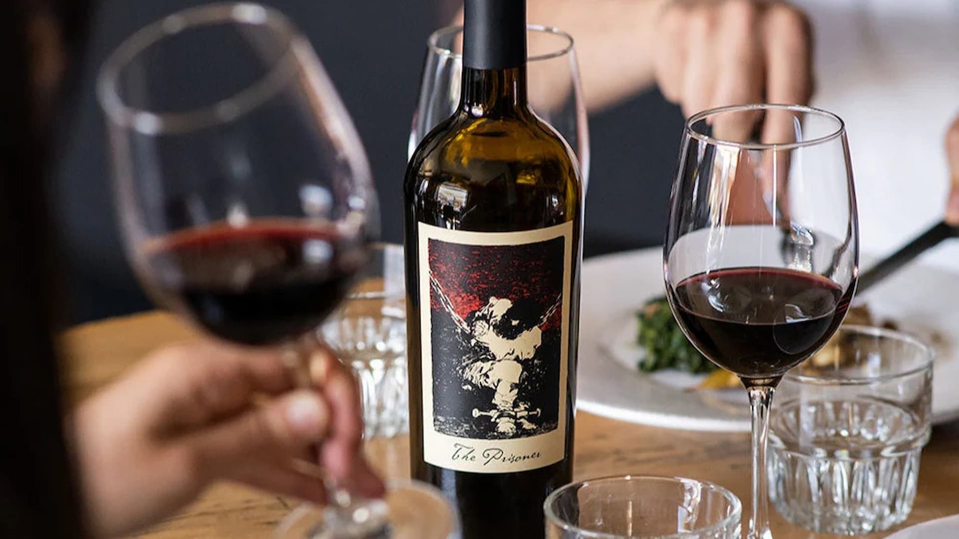 Bottle of red wine with two glasses