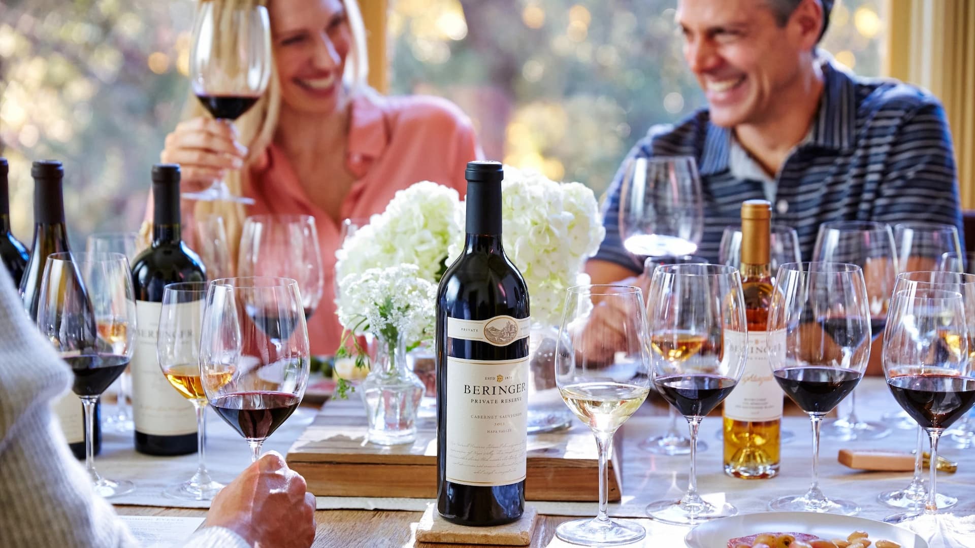 People enjoying wine at a table gathering