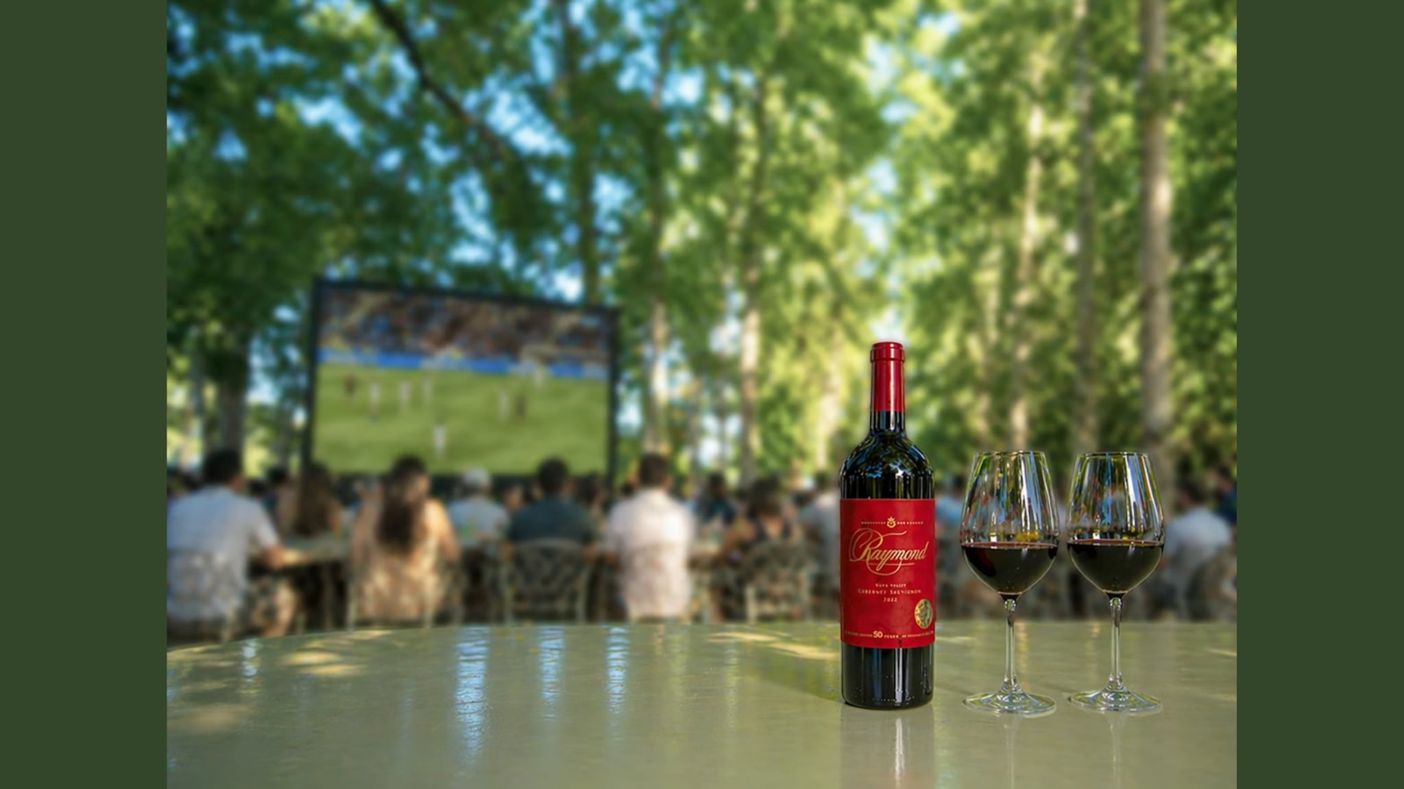 Red wine bottle and glasses at outdoor screening