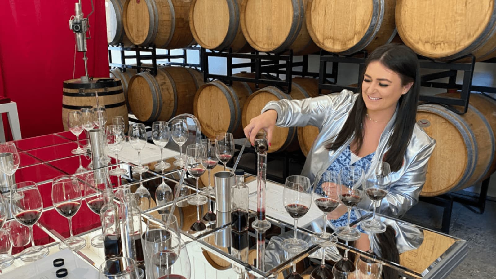 Woman pouring wine in a winery