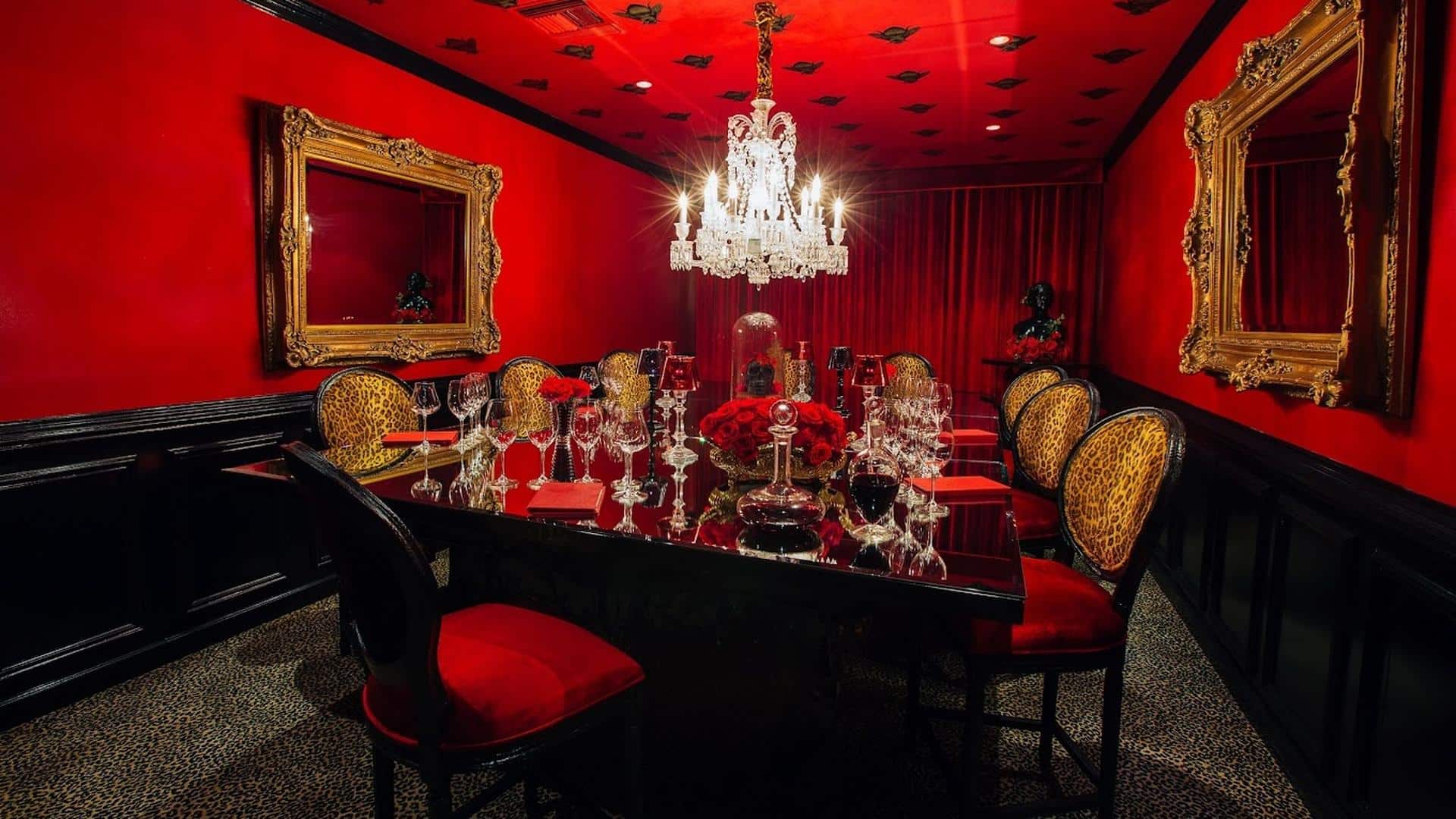 Luxurious red dining room with chandelier.