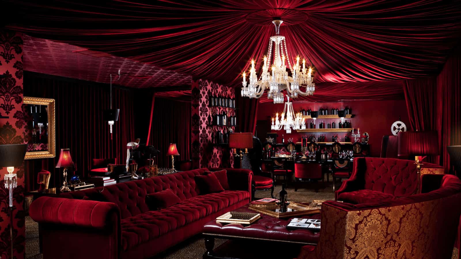 Luxurious red velvet bar lounge with chandelier.