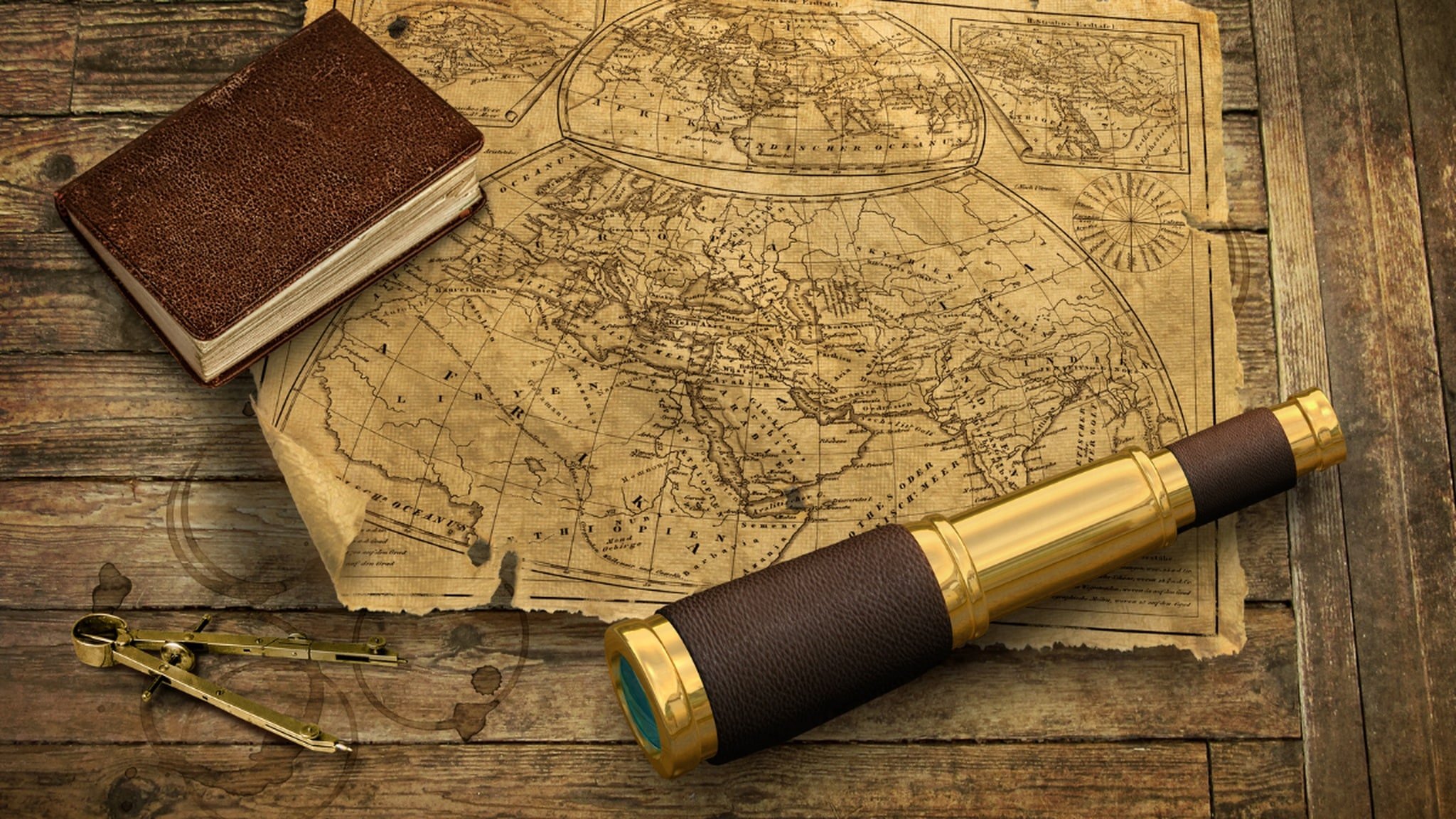 Vintage map with compass, book, and telescope.