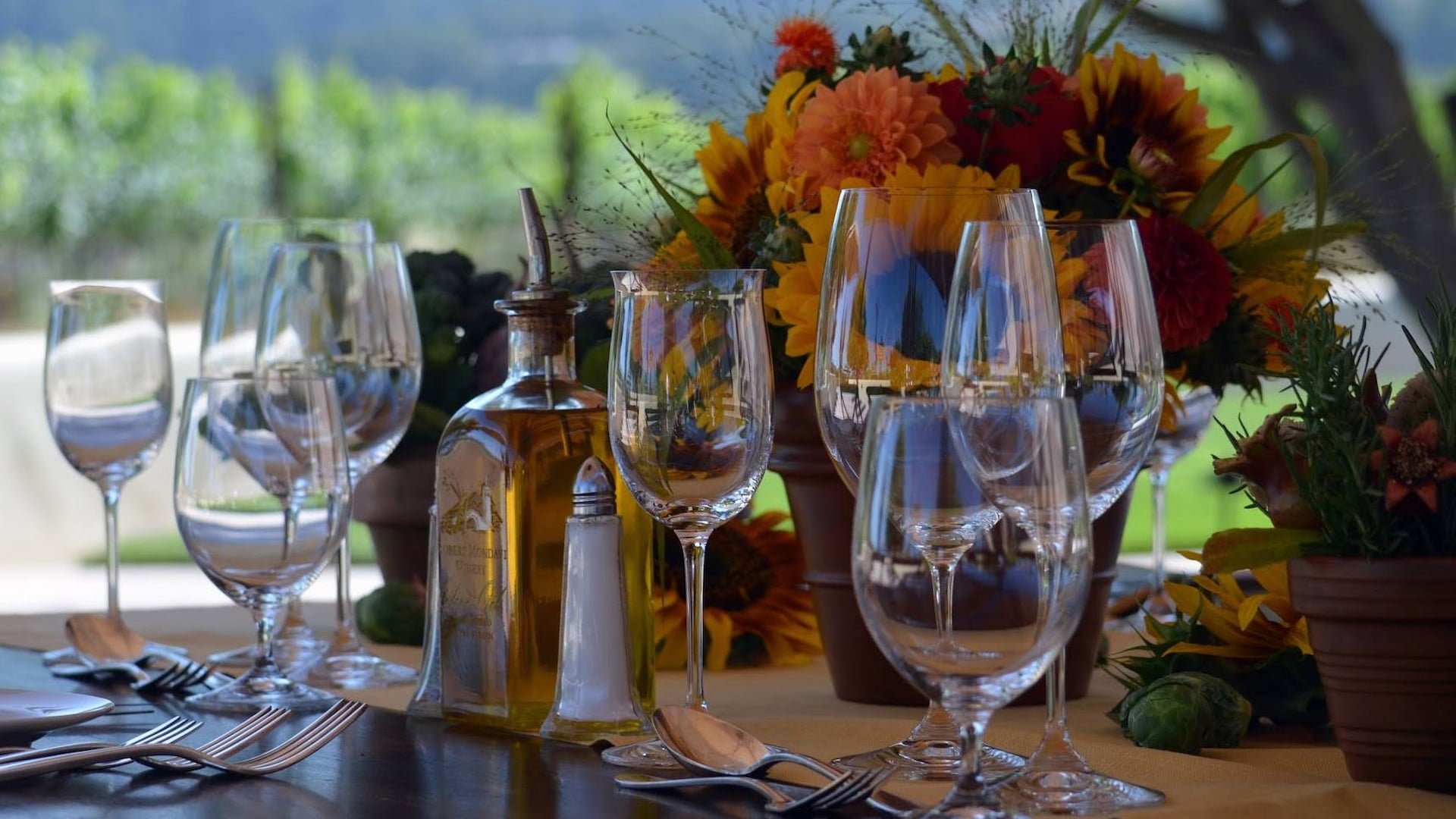 Elegantly set table with flowers and wine glasses.
