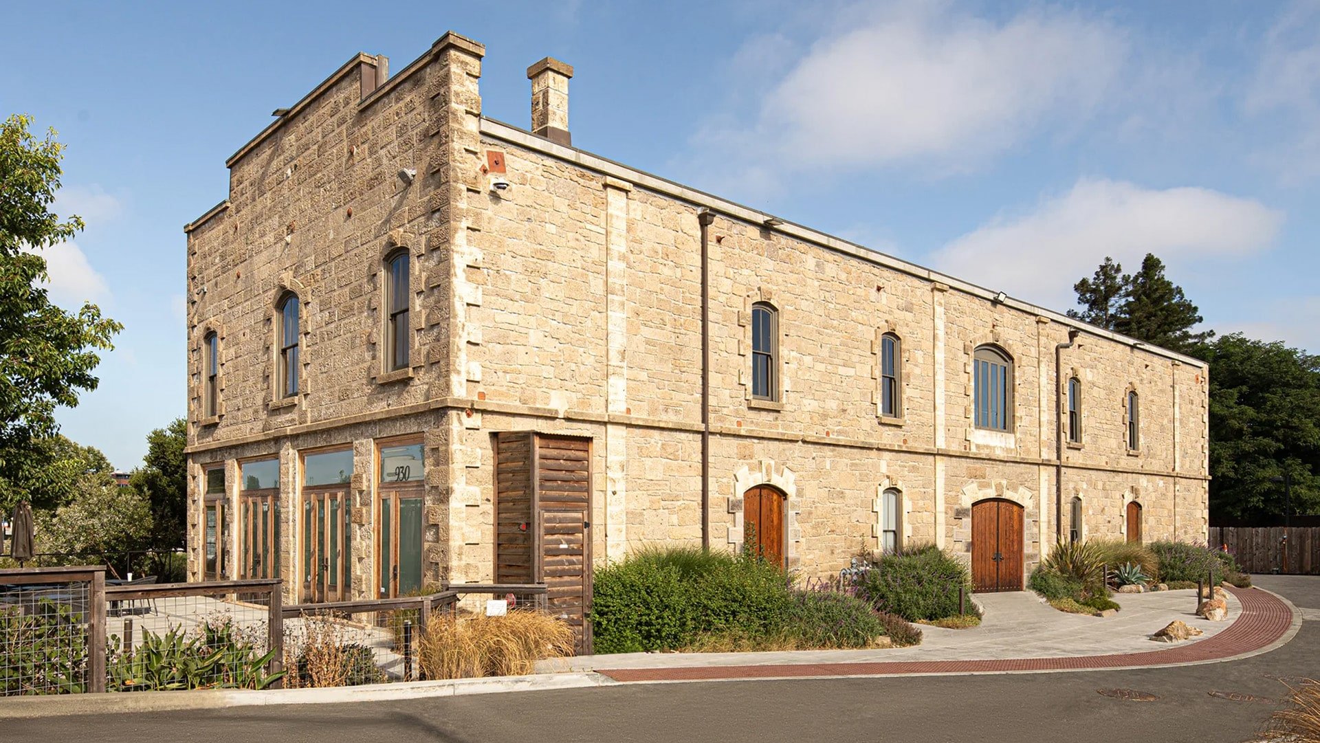 Historic stone building with arched windows and doors.