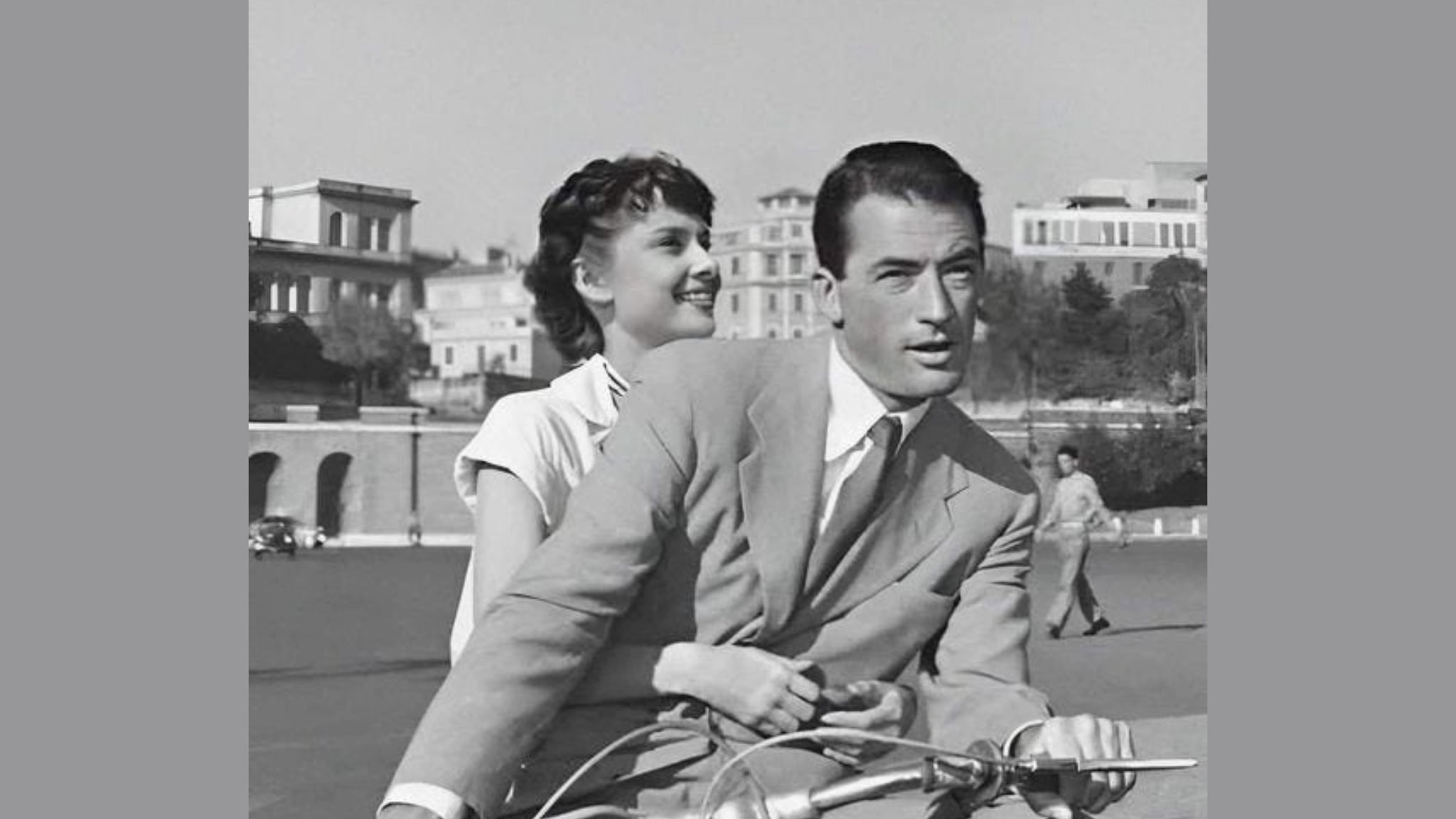 Couple riding scooter in vintage black-and-white city scene