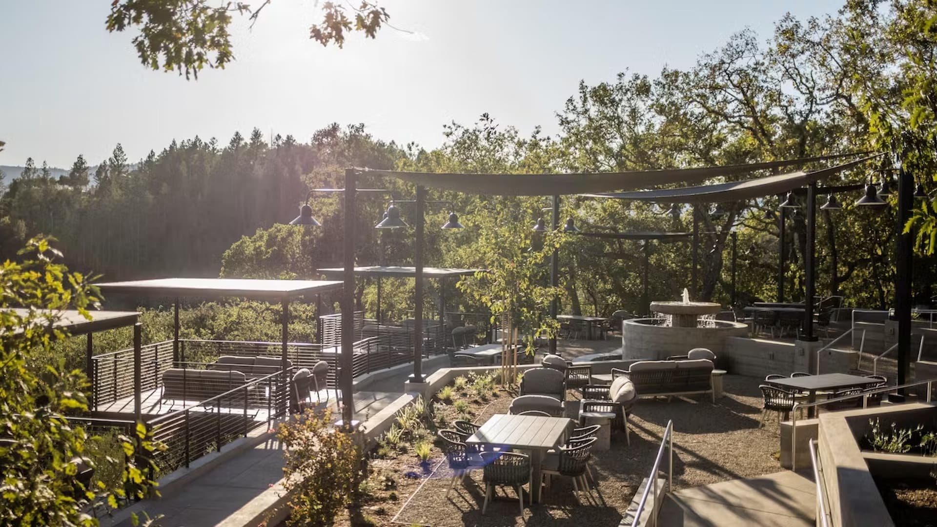 Scenic outdoor patio with tables and shade canopies