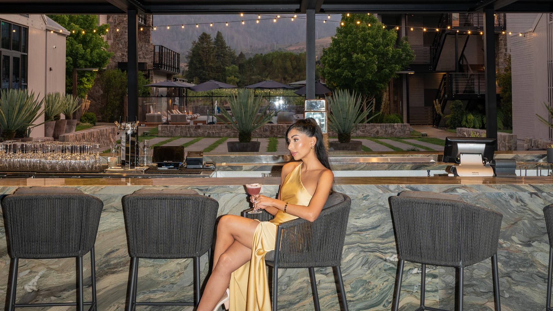 Woman in yellow dress at outdoor bar