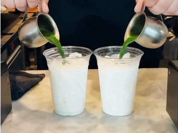 Green matcha poured into two milk drinks