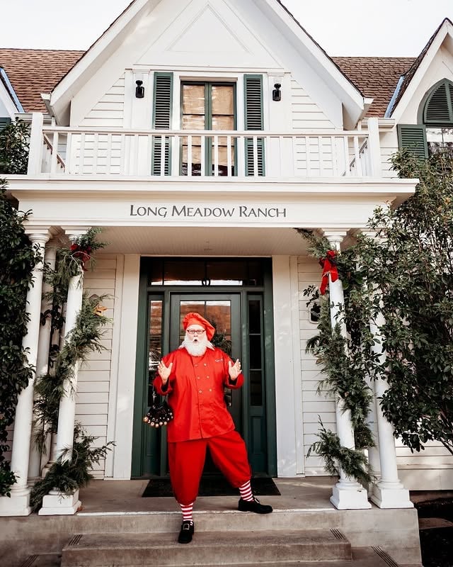 Santa-costumed man stands outside Long Meadow Ranch entrance.
