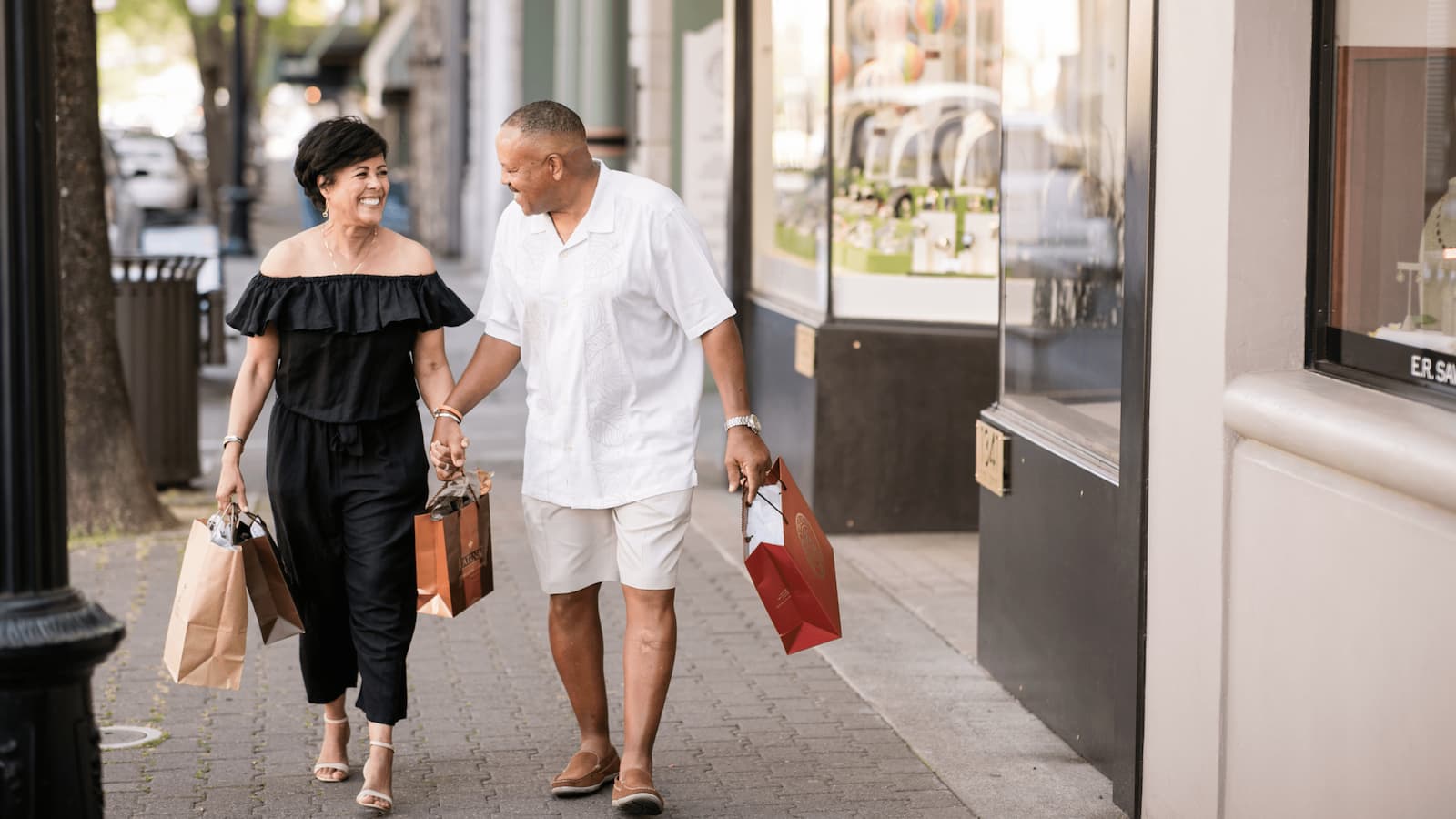 Couple walking with shopping bags.