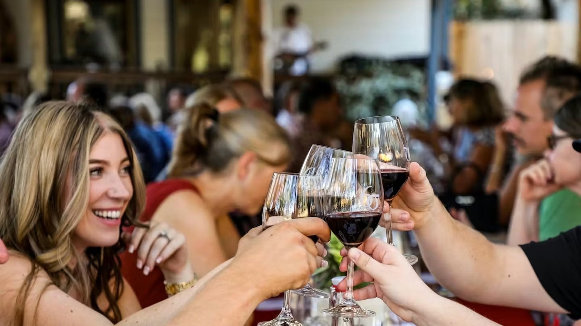 Friends toasting red wine at outdoor restaurant