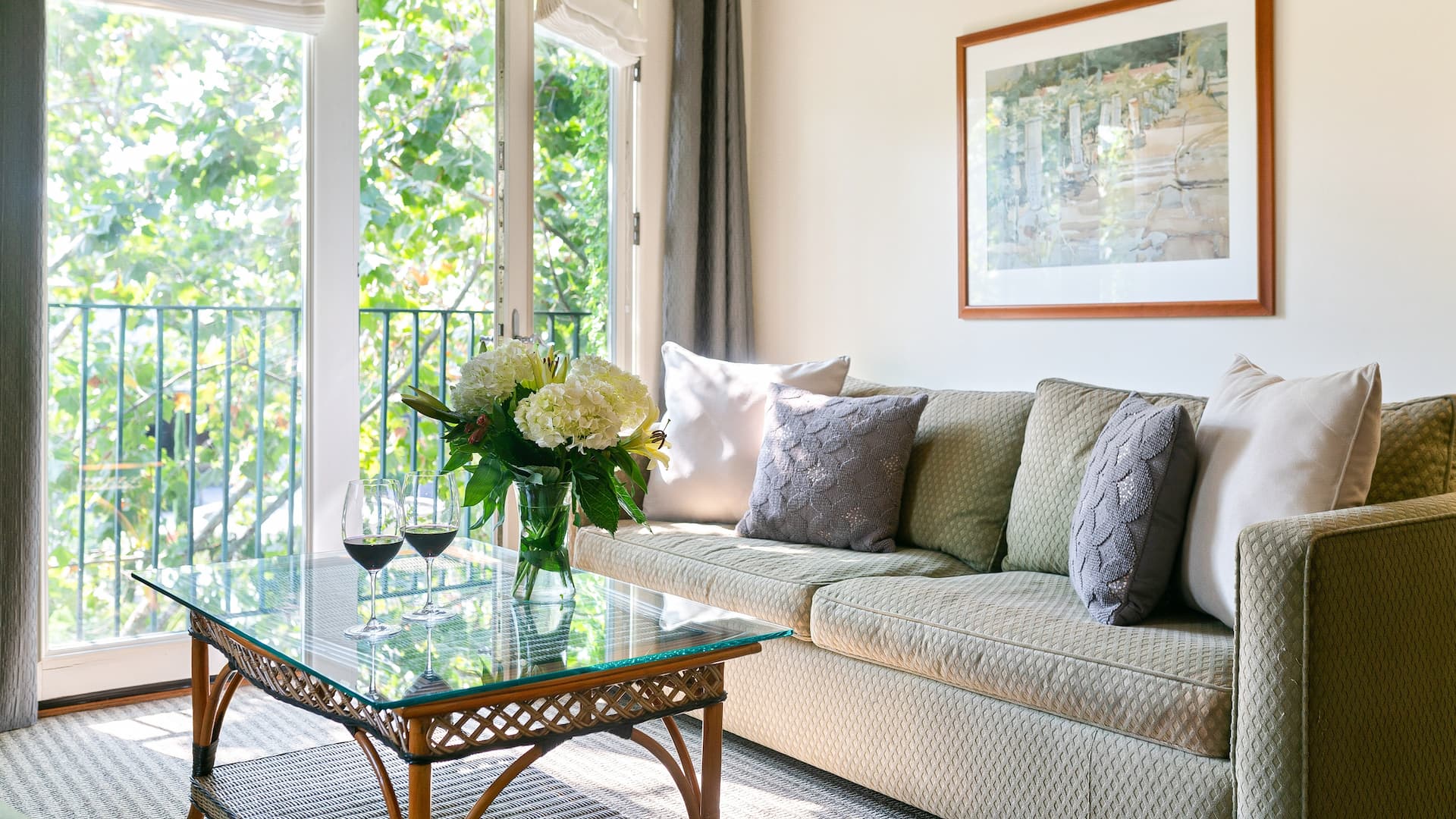 Cozy living room with sofa and balcony view.