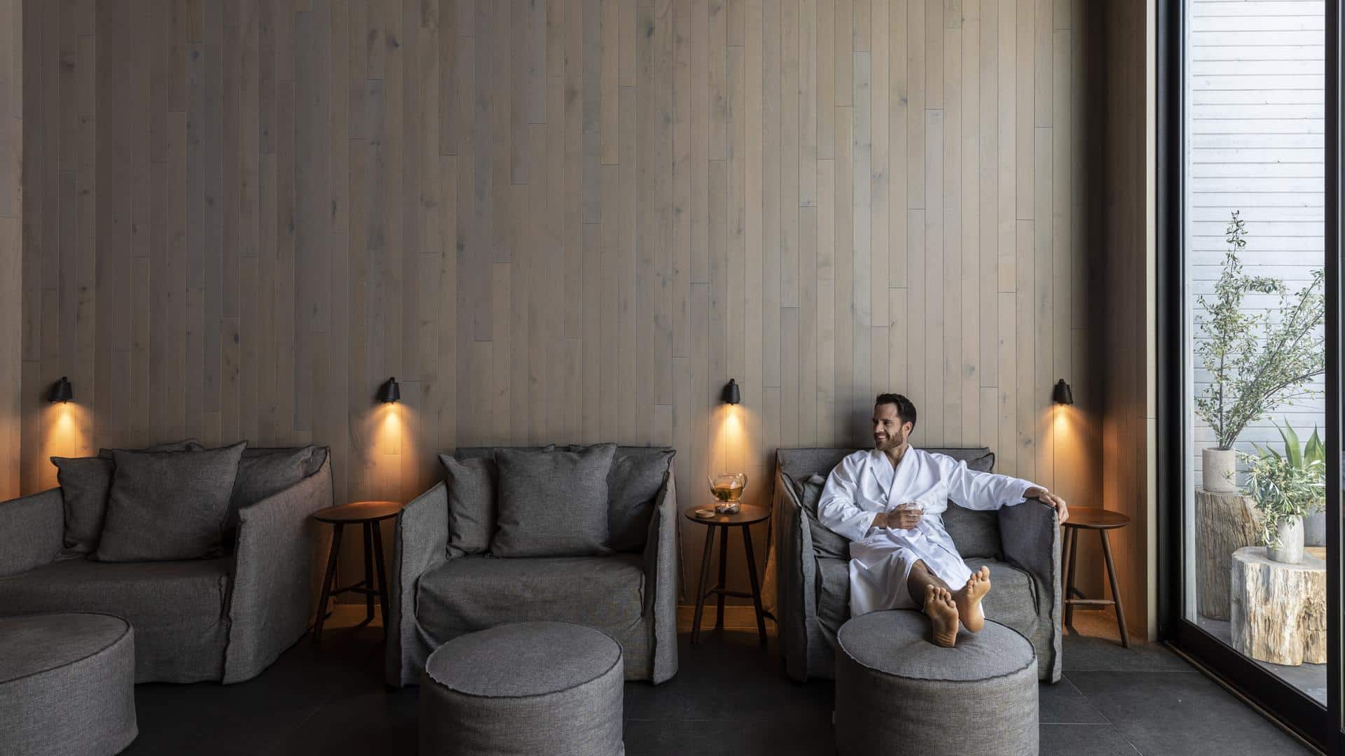 Man relaxing in a cozy lounge area.