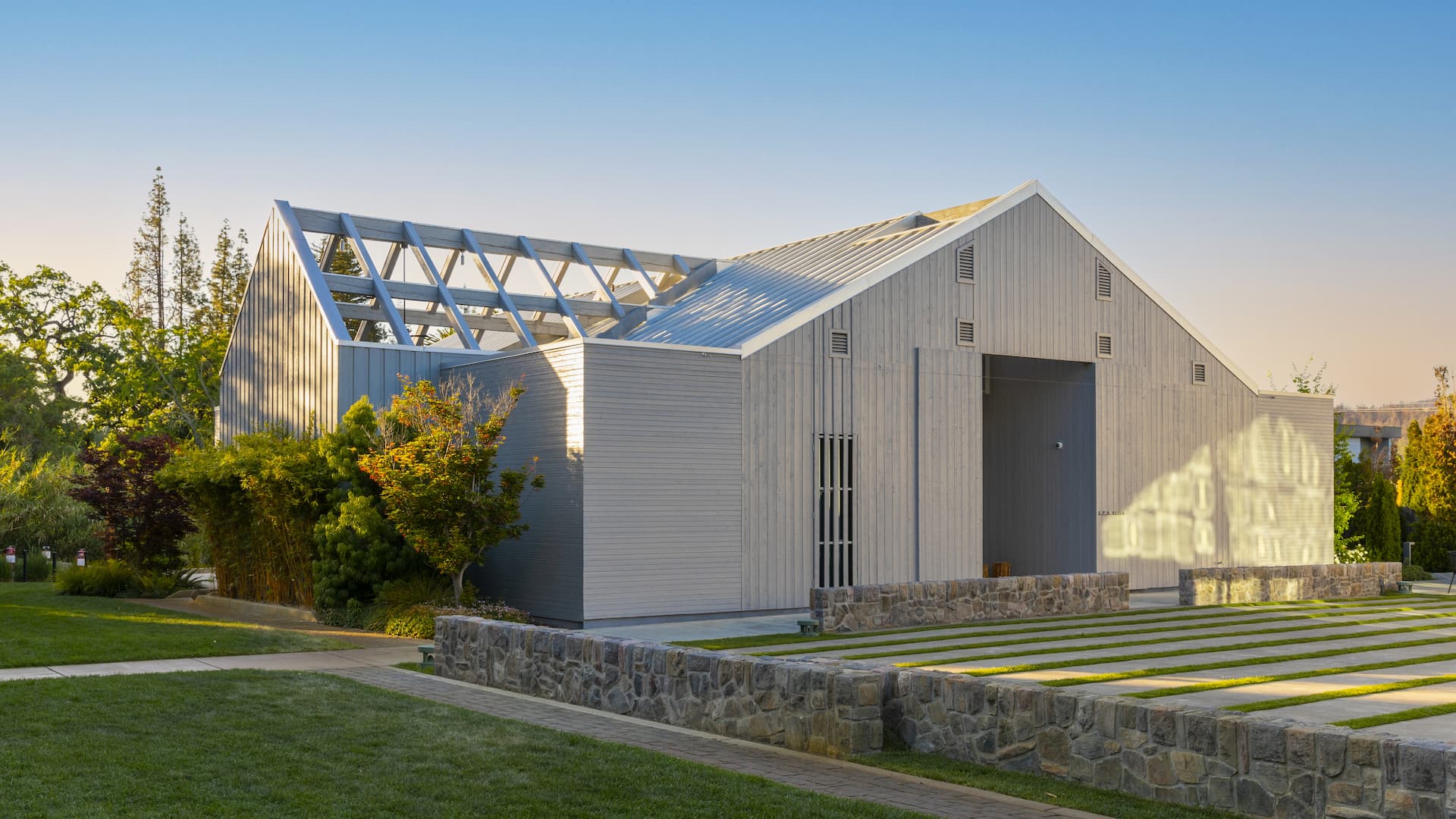 Modern barn-style building with open roof structure.