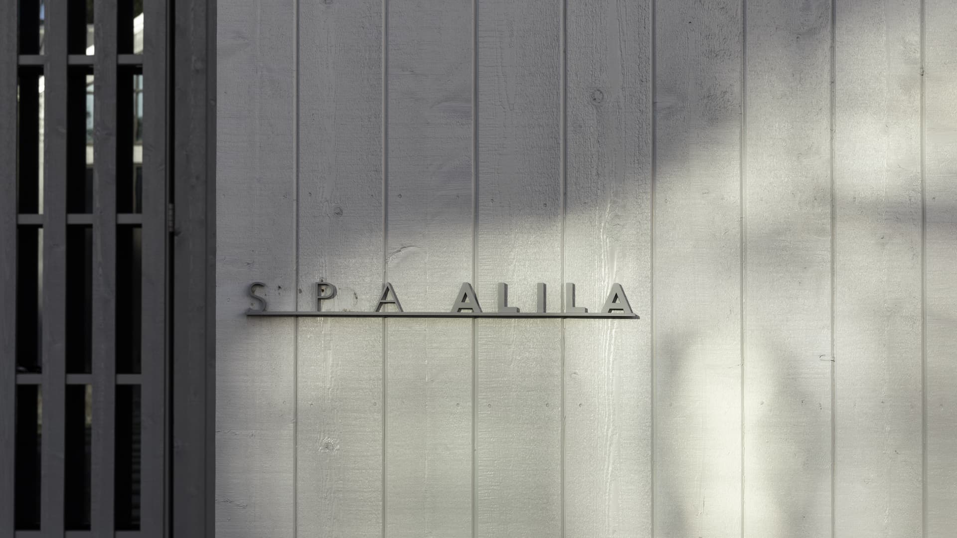 Spa Alila logo on wooden wall