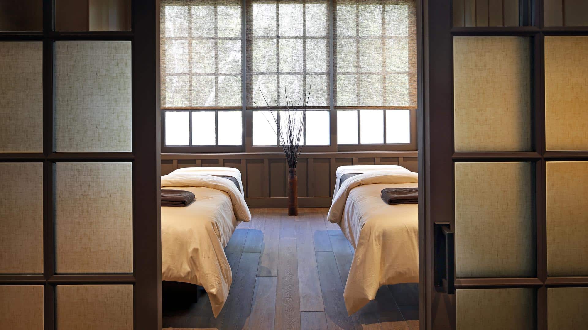 Serene spa room with two massage tables.