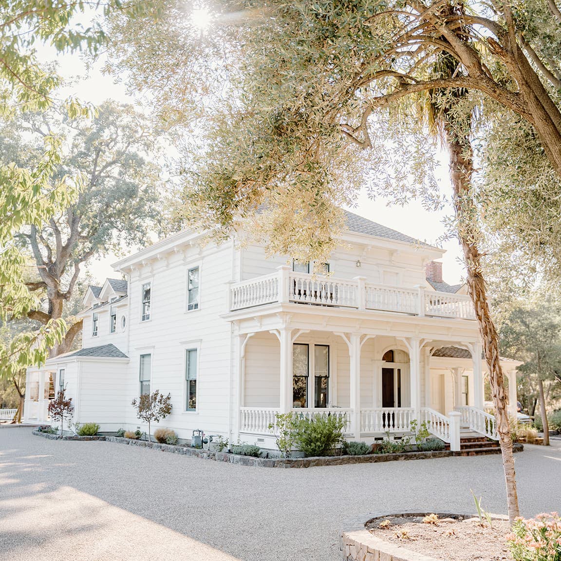 White Victorian house with wraparound porch and balcony