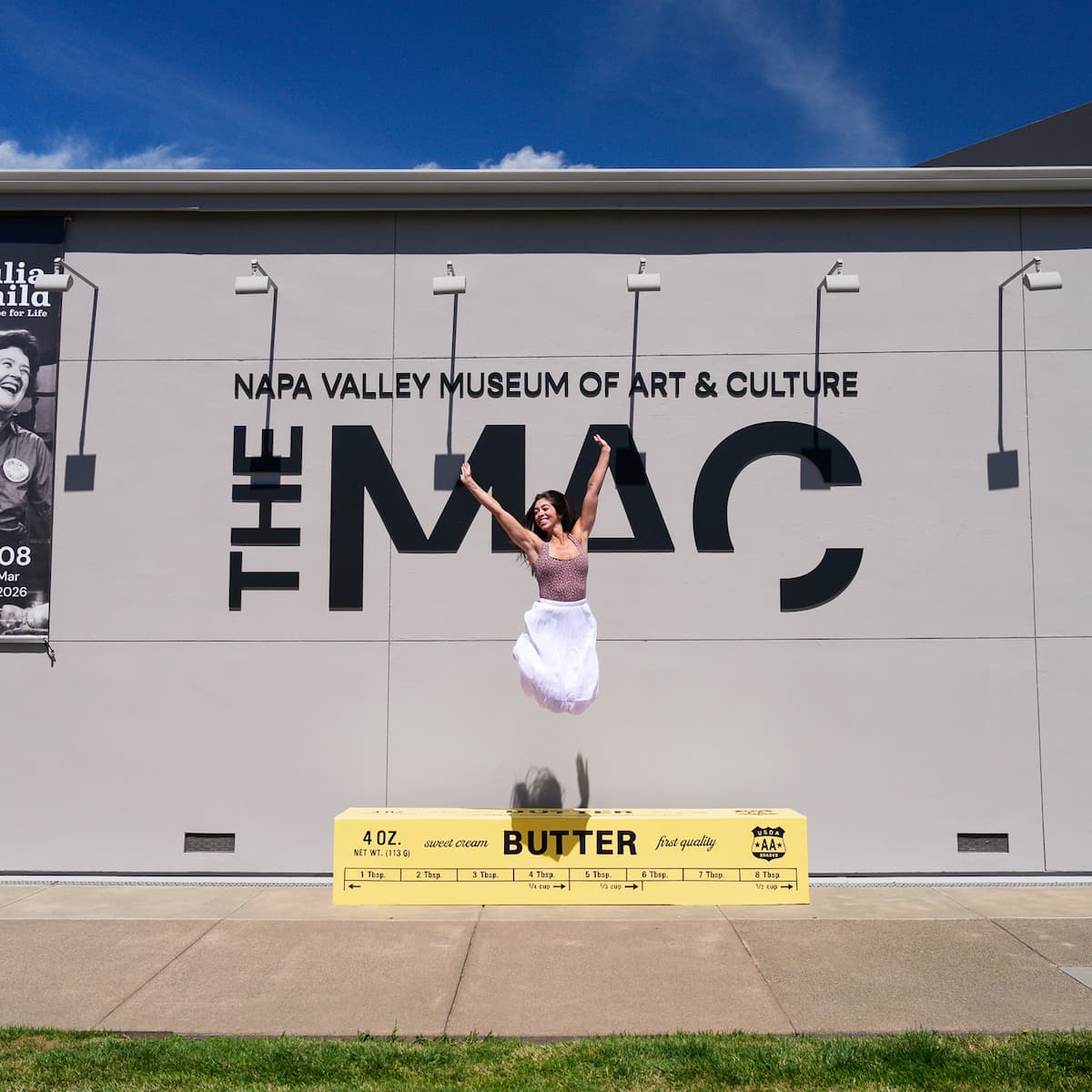 Woman jumping in front of Napa Valley Museum