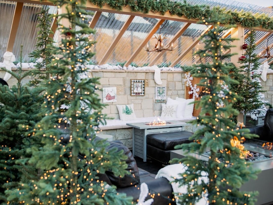 Cozy outdoor winter decor with Christmas lights and snow.