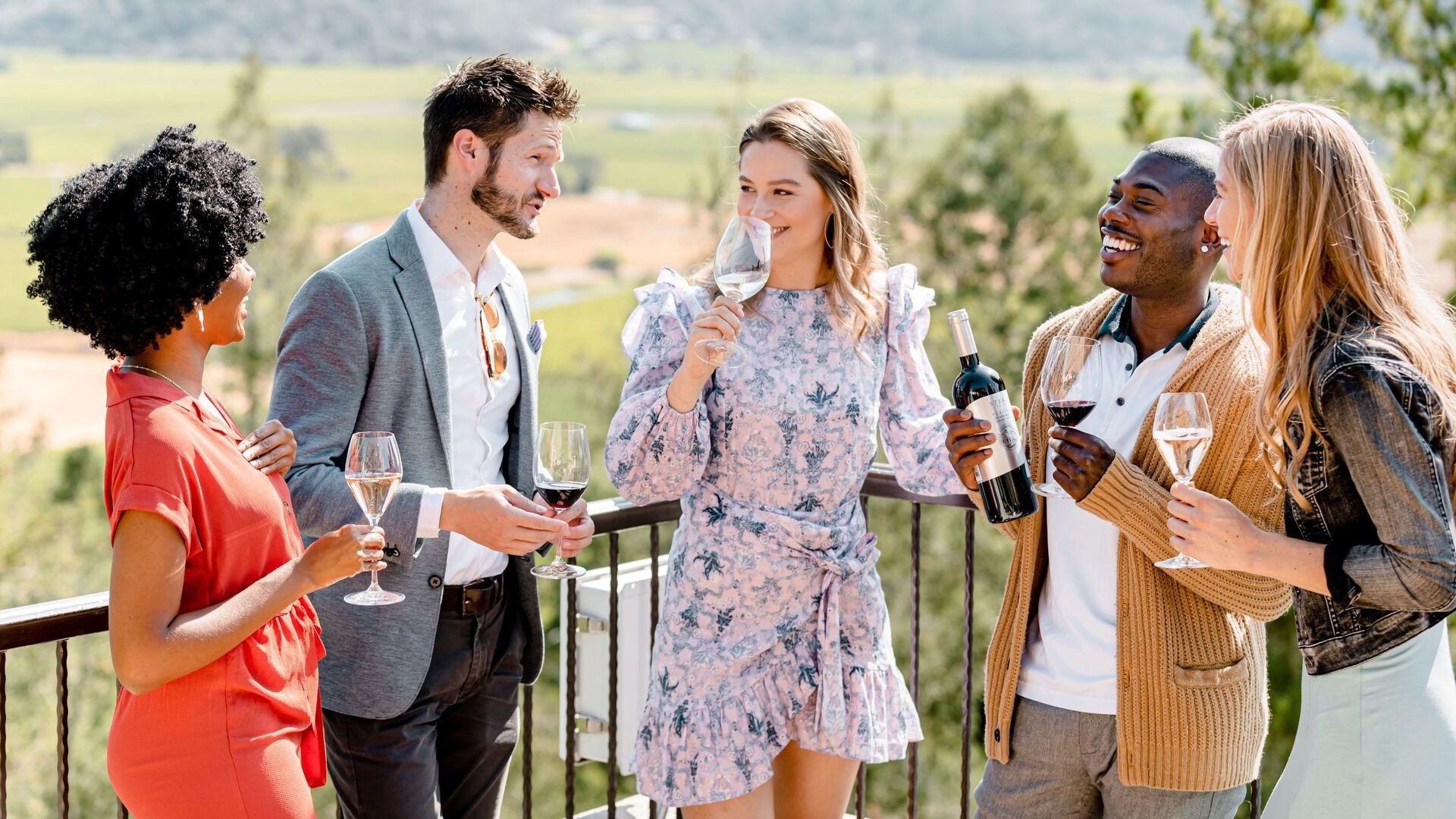 Friends enjoying wine on a scenic balcony