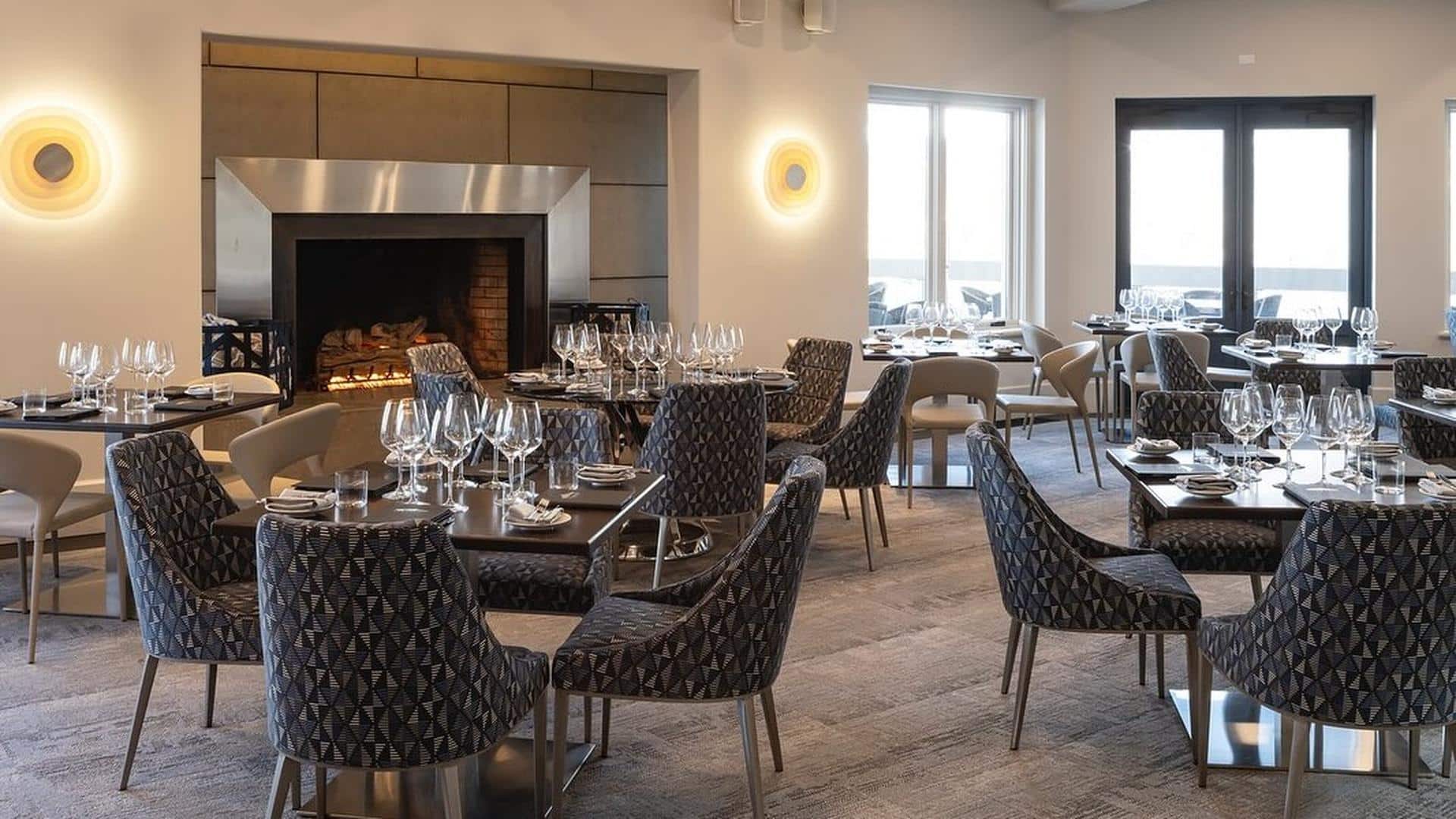 Elegant restaurant dining area with fireplace and tables.
