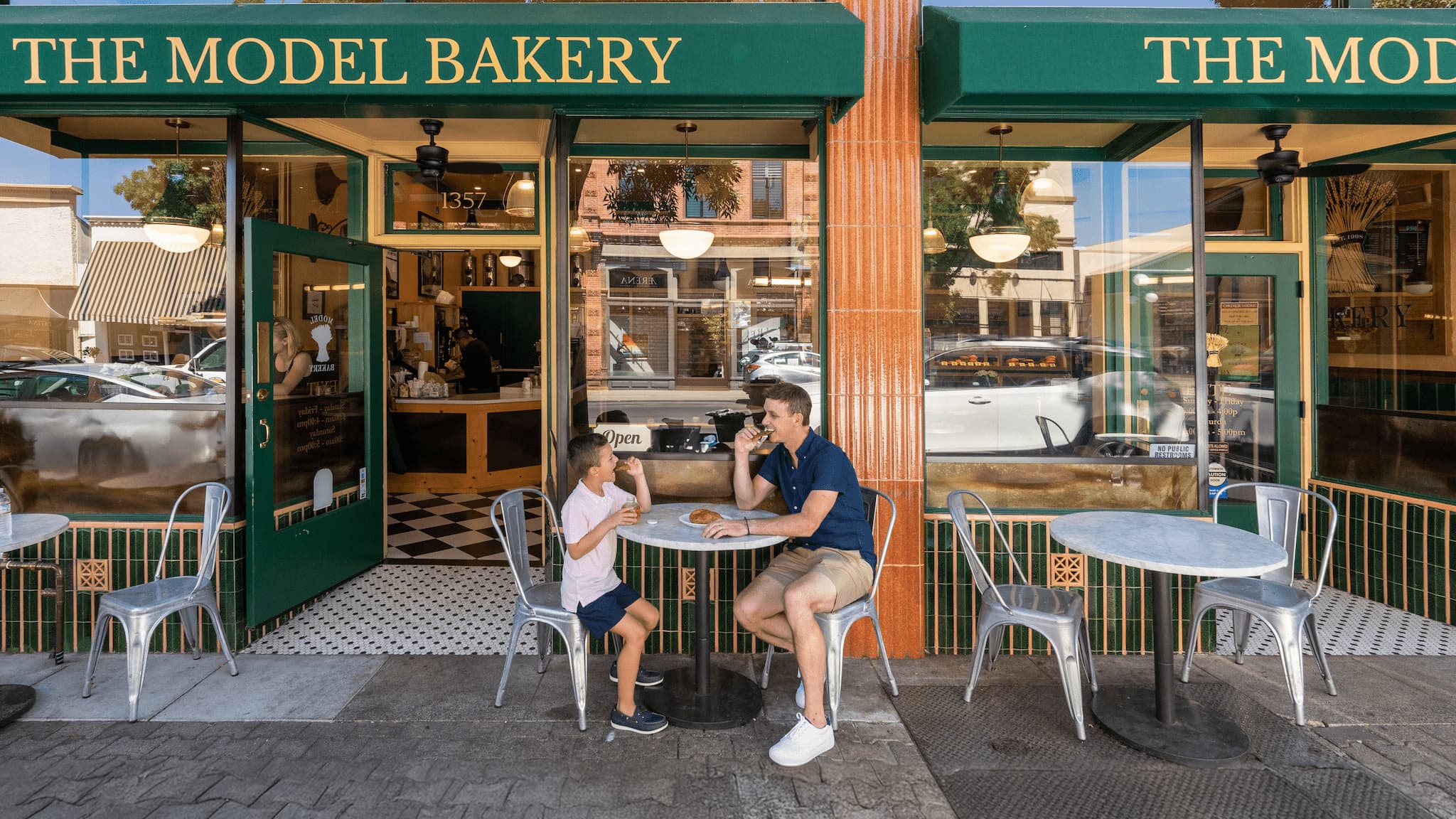 People enjoying pastries outside The Model Bakery