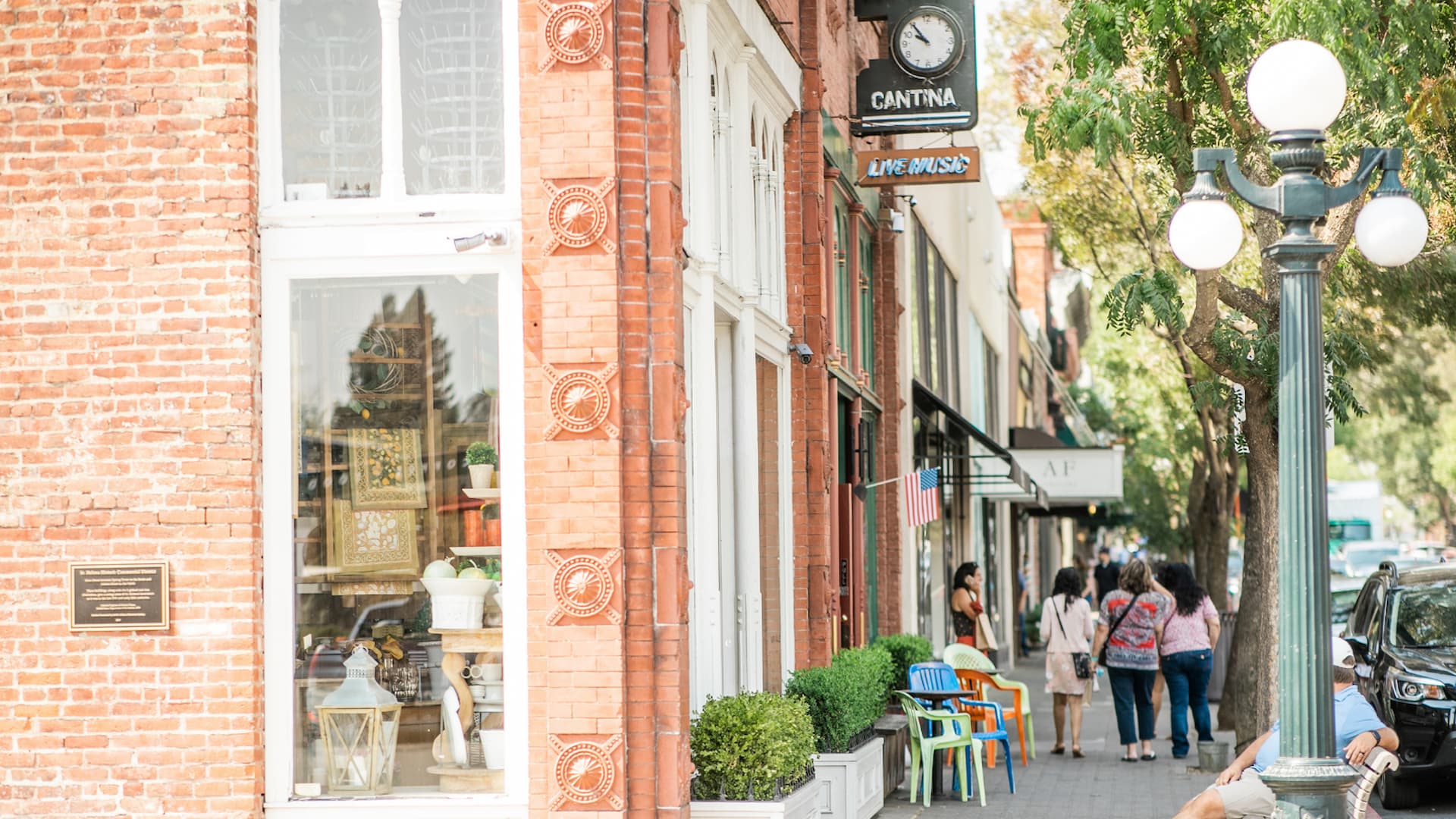 Urban street with shops and pedestrians.