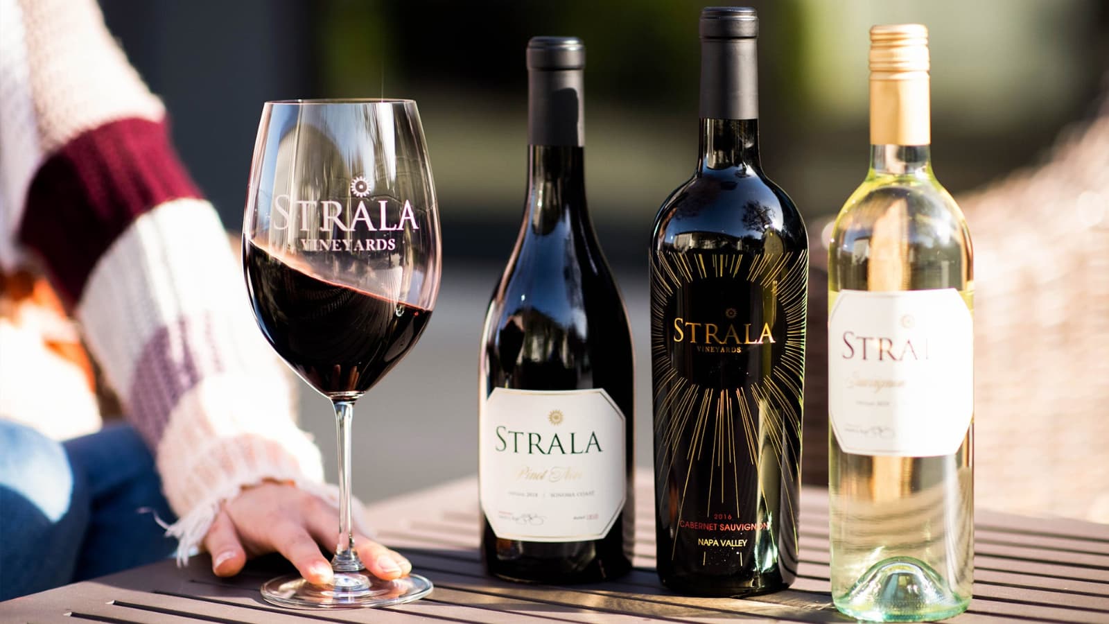Strala Vineyards wine bottles and filled glass.