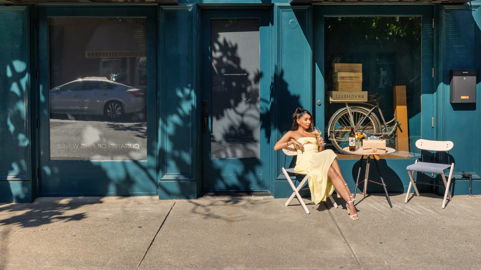 Woman in yellow dress at outdoor café table