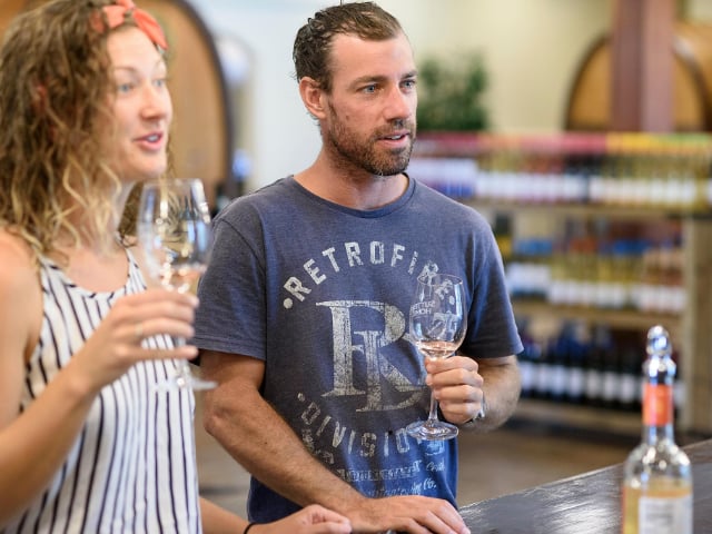 Two people tasting wine in a shop